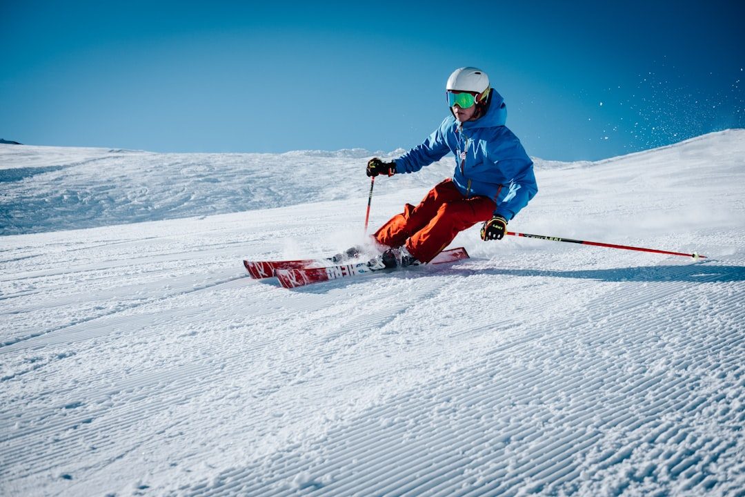 Ski coach and athlete reviewing a training run on the mountain