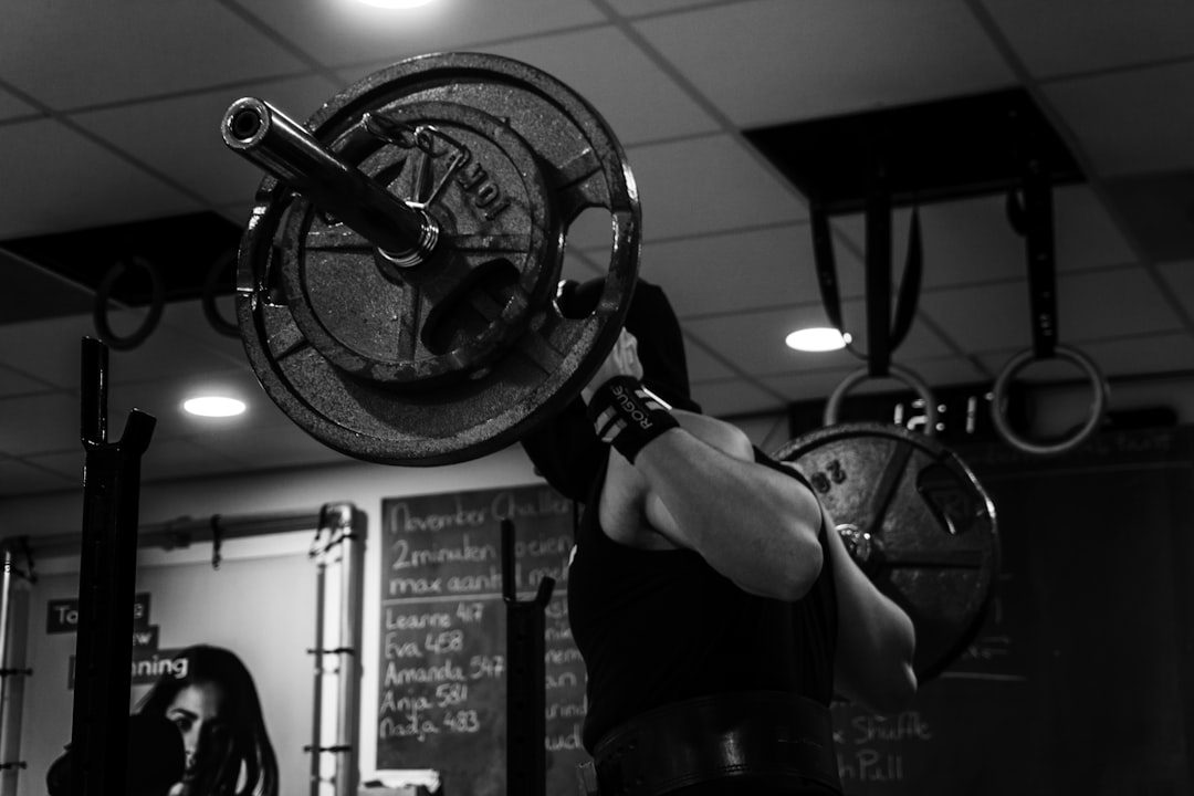 Athletes training with barbells inside a CrossFit box