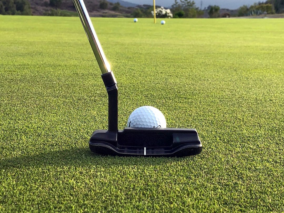 Golfer practising a short-game shot near the green