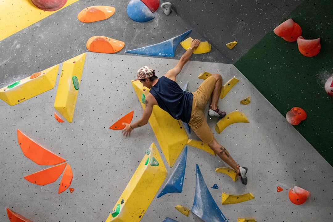 Climber moving across a steep indoor training wall
