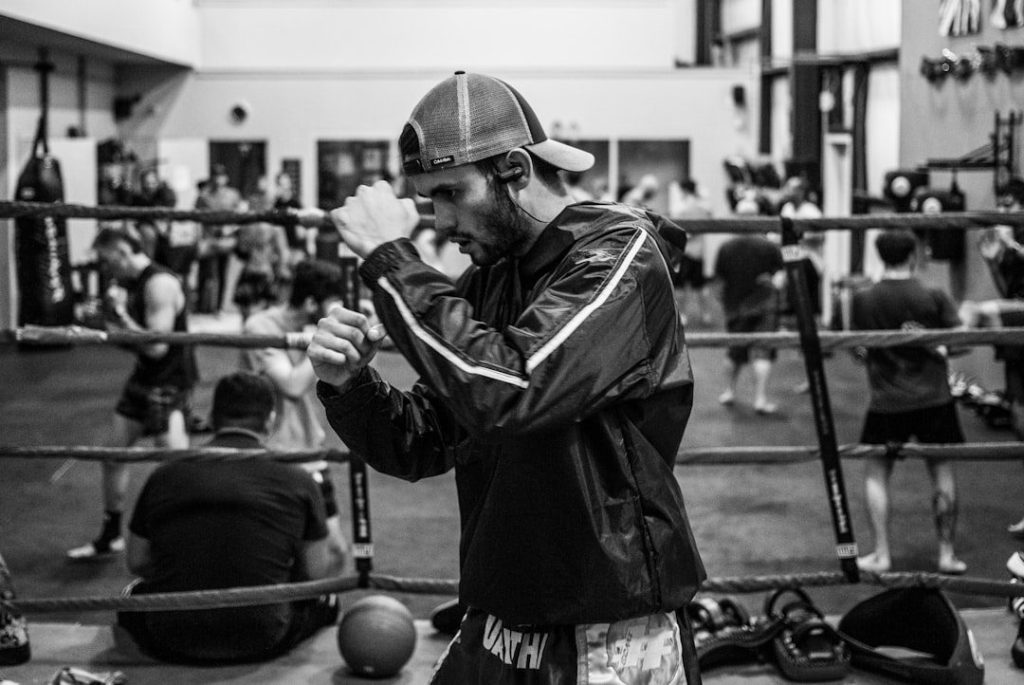 Boxer practising controlled pad combinations with a coach