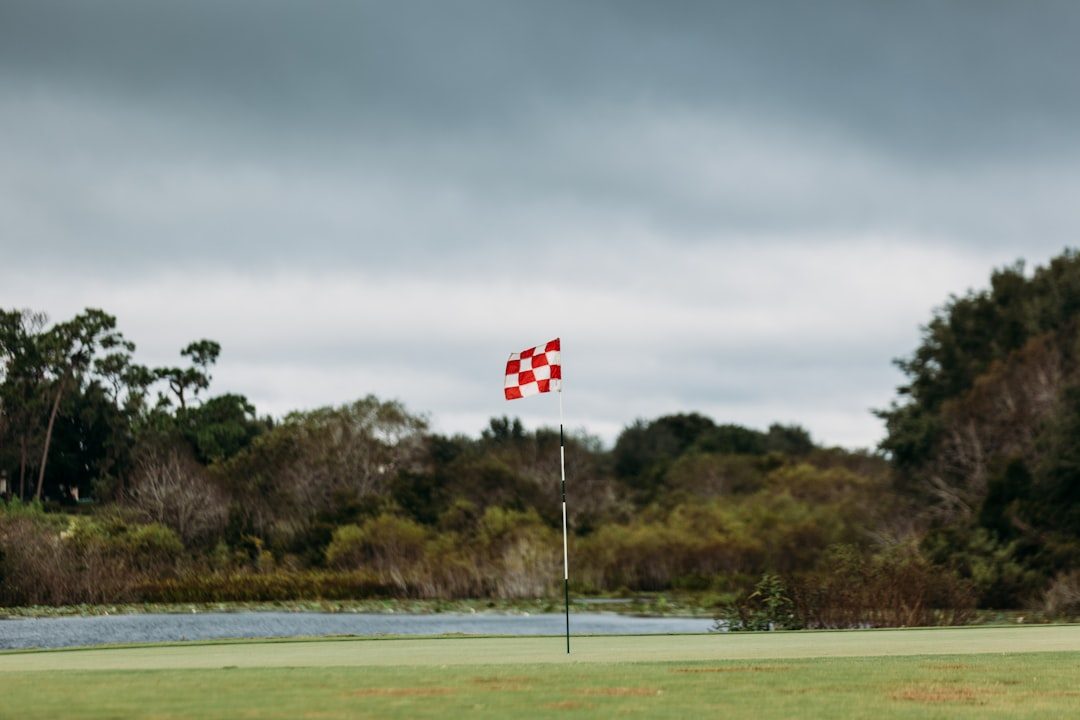 Golf coach observing a player during an outdoor lesson