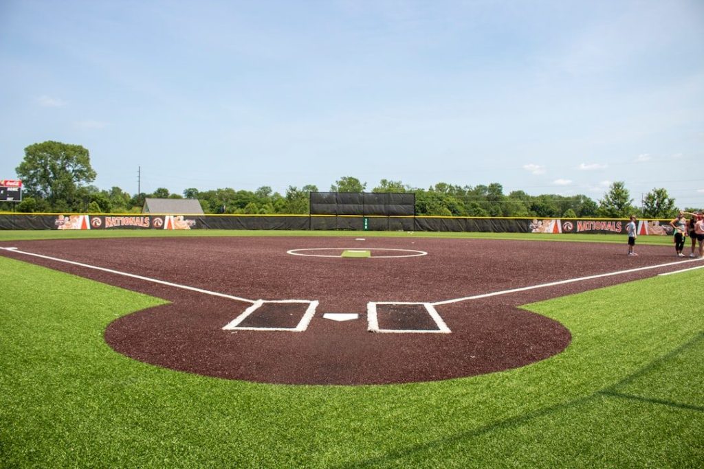 Baseball coach guiding a player through position-specific practice