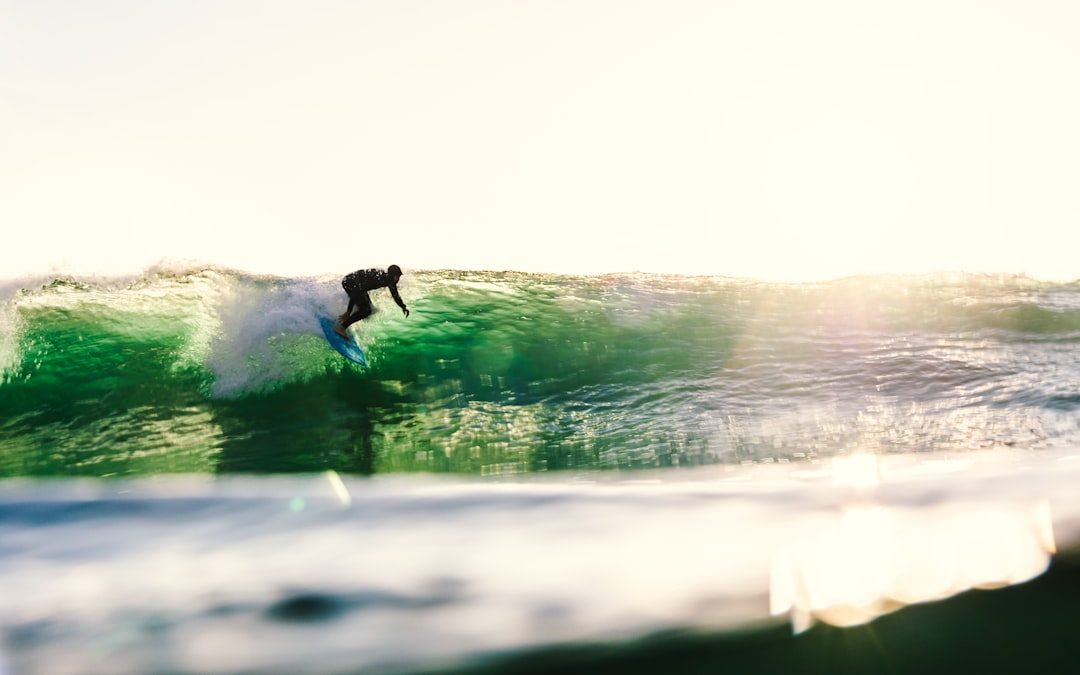 Surfer riding a clean ocean wave near the beach