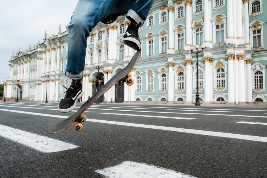 Skater practising an ollie with a coach nearby