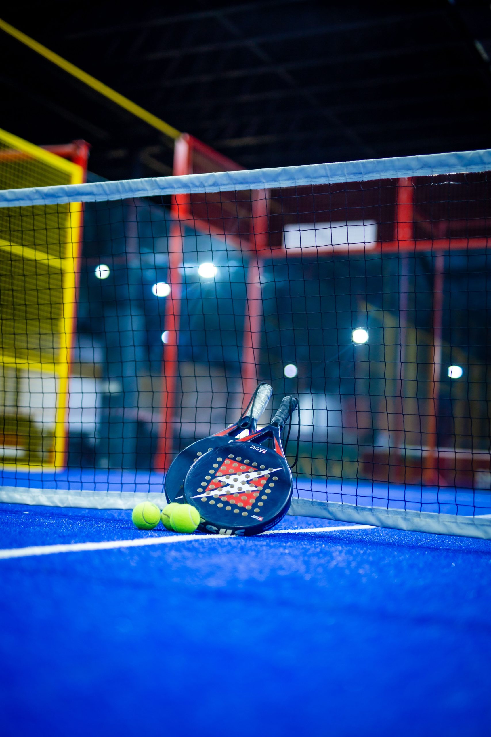 Padel racket and ball prepared for a court booking