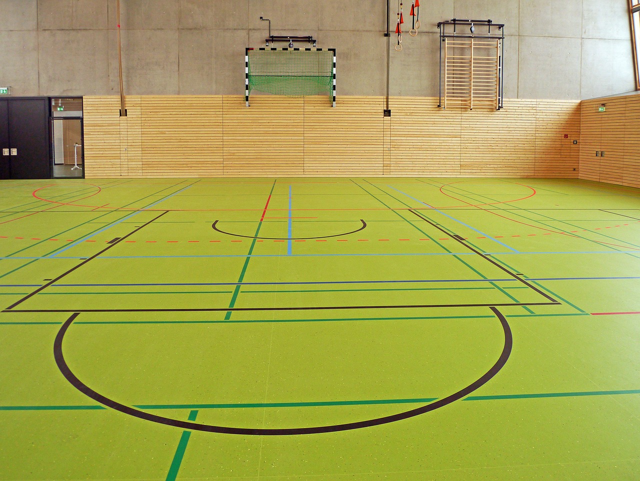 Sports team practicing drills together on a field