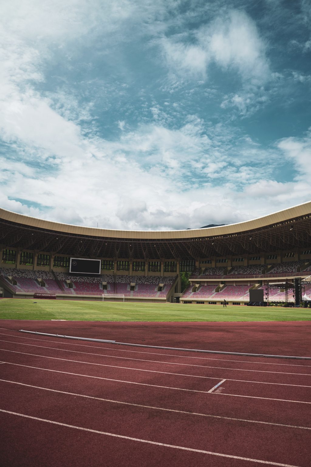 Athlete training with cones on an outdoor sports field