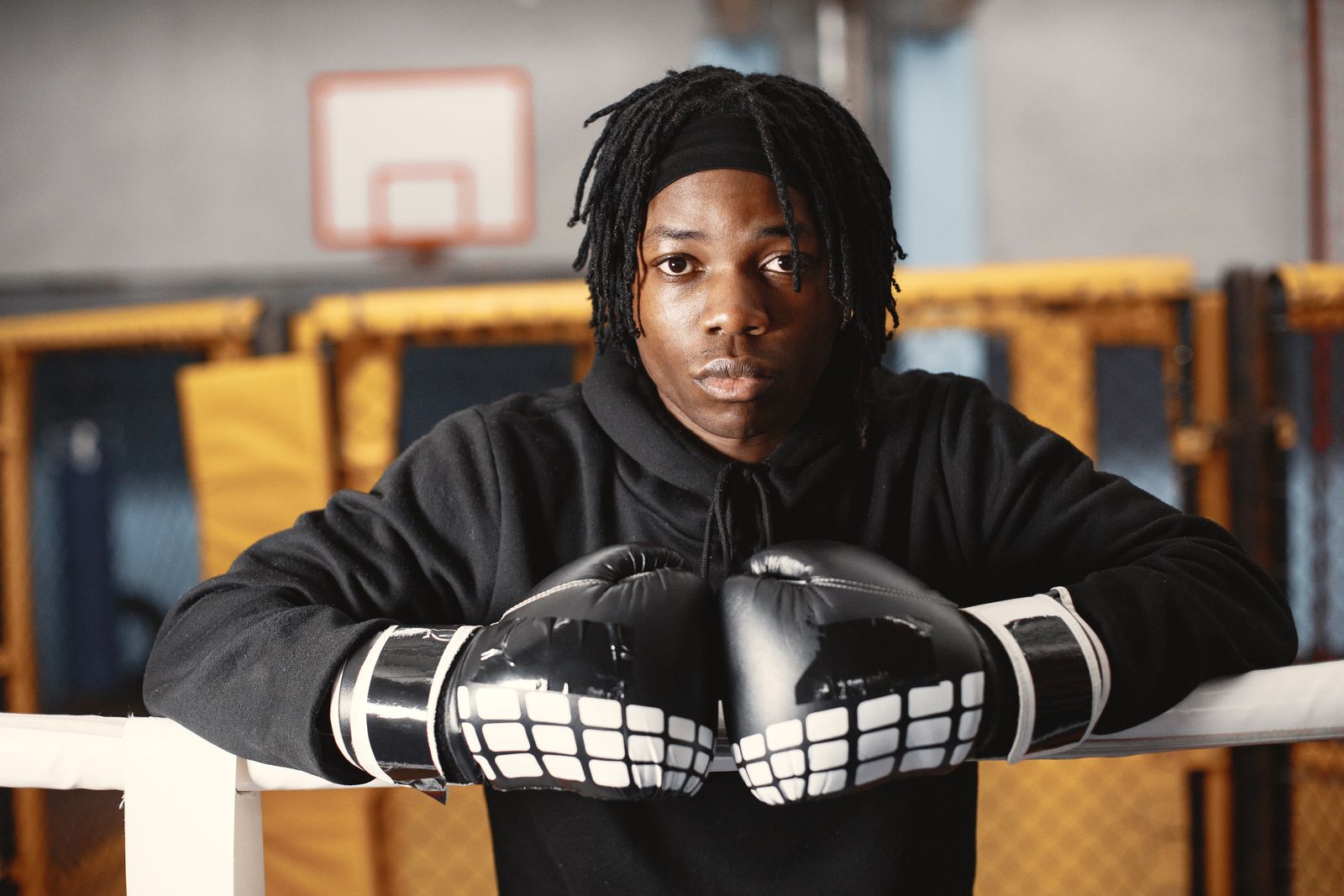 Young boxer wearing gloves in a gym