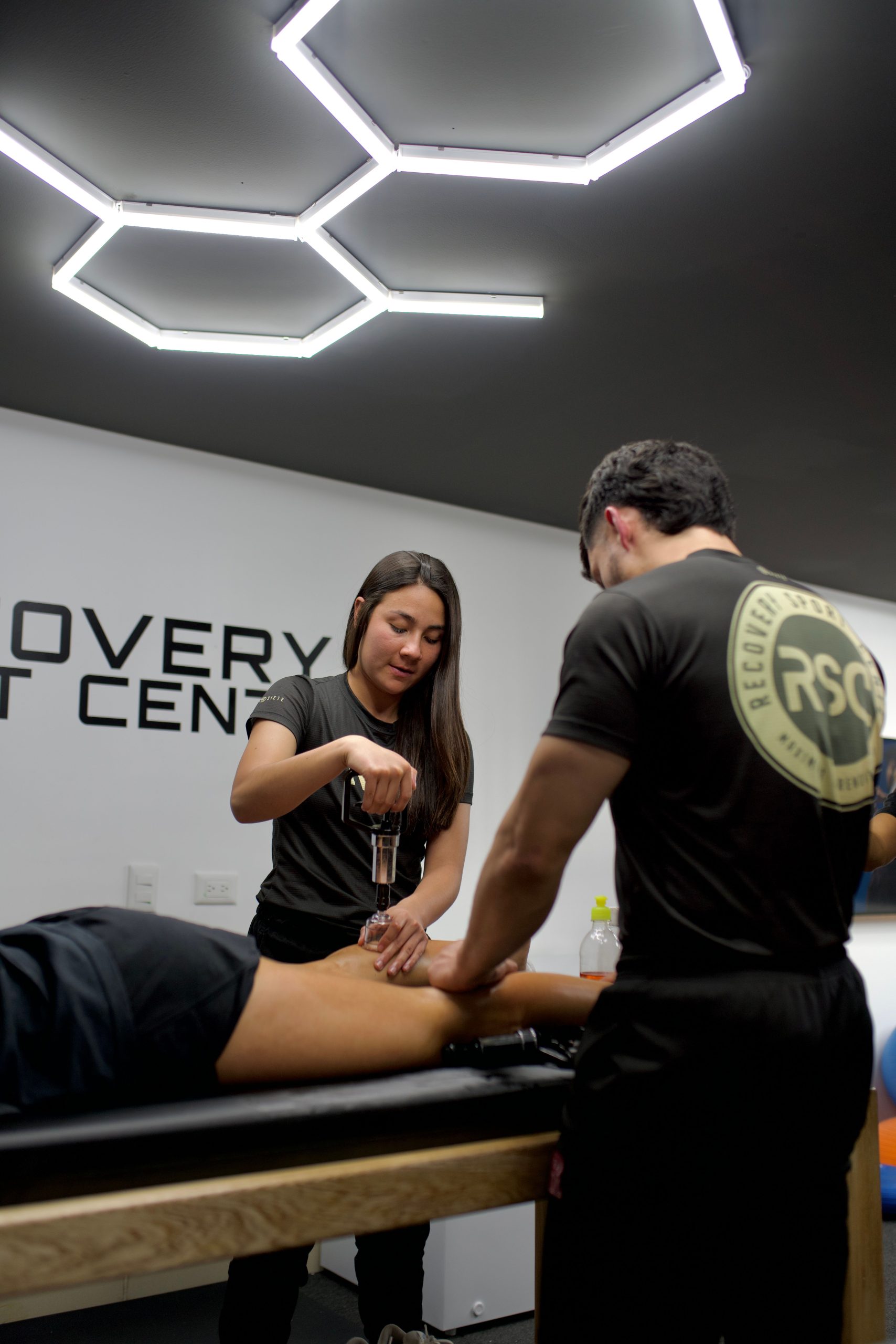 Physiotherapists providing treatment in a sports recovery clinic