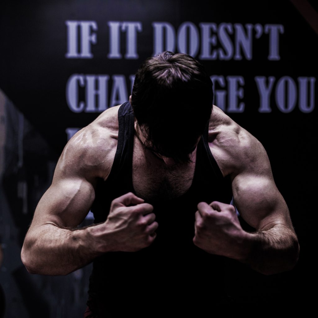 Strong male bodybuilder posing in a gym