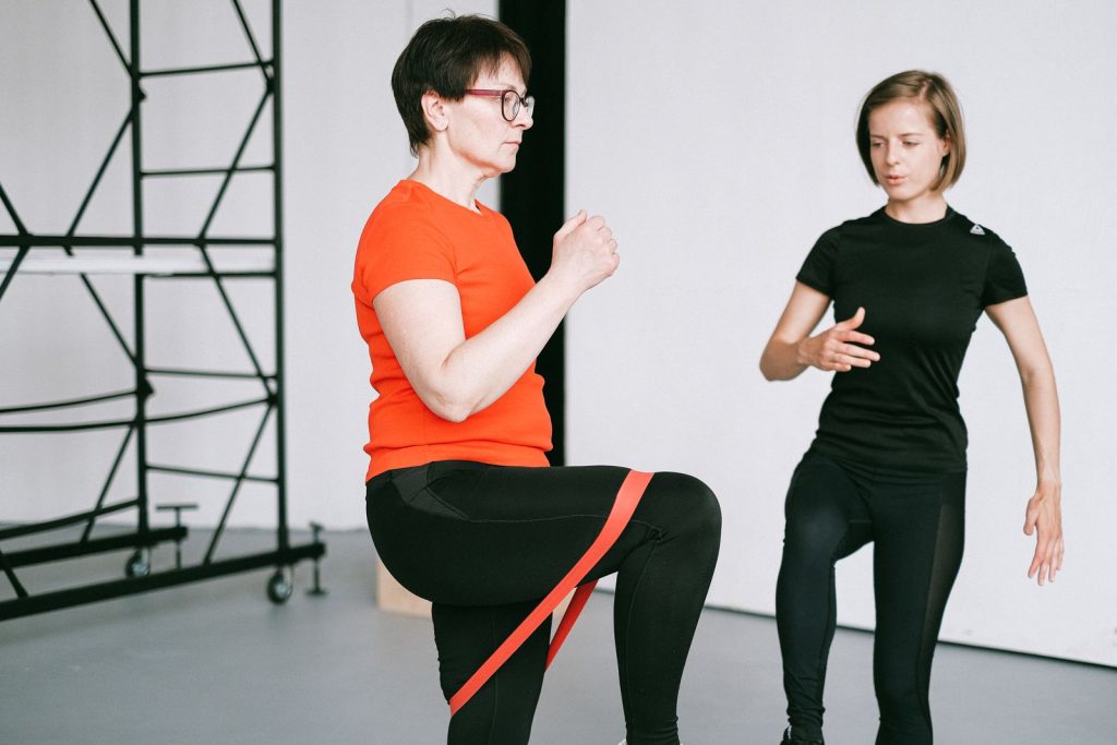Female trainer guiding resistance band training