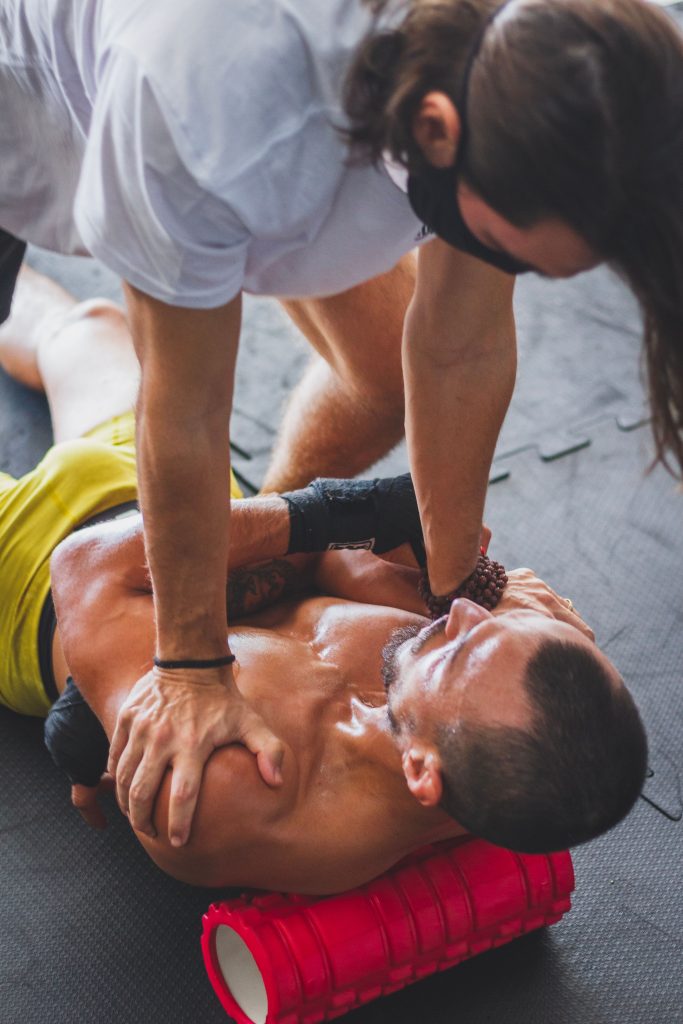 Athlete receiving assisted recovery treatment during rehabilitation
