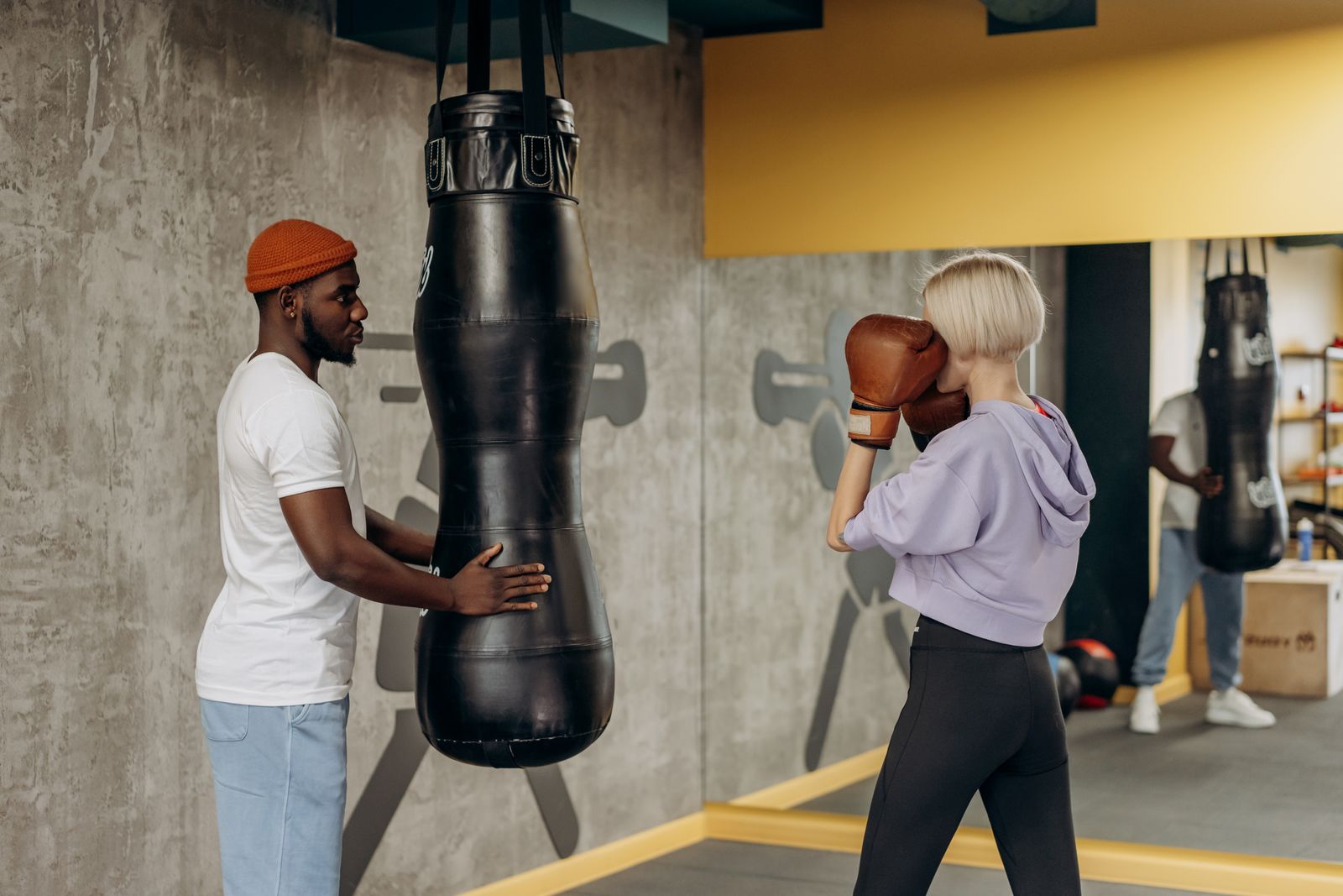 Woman practicing boxing with a coach