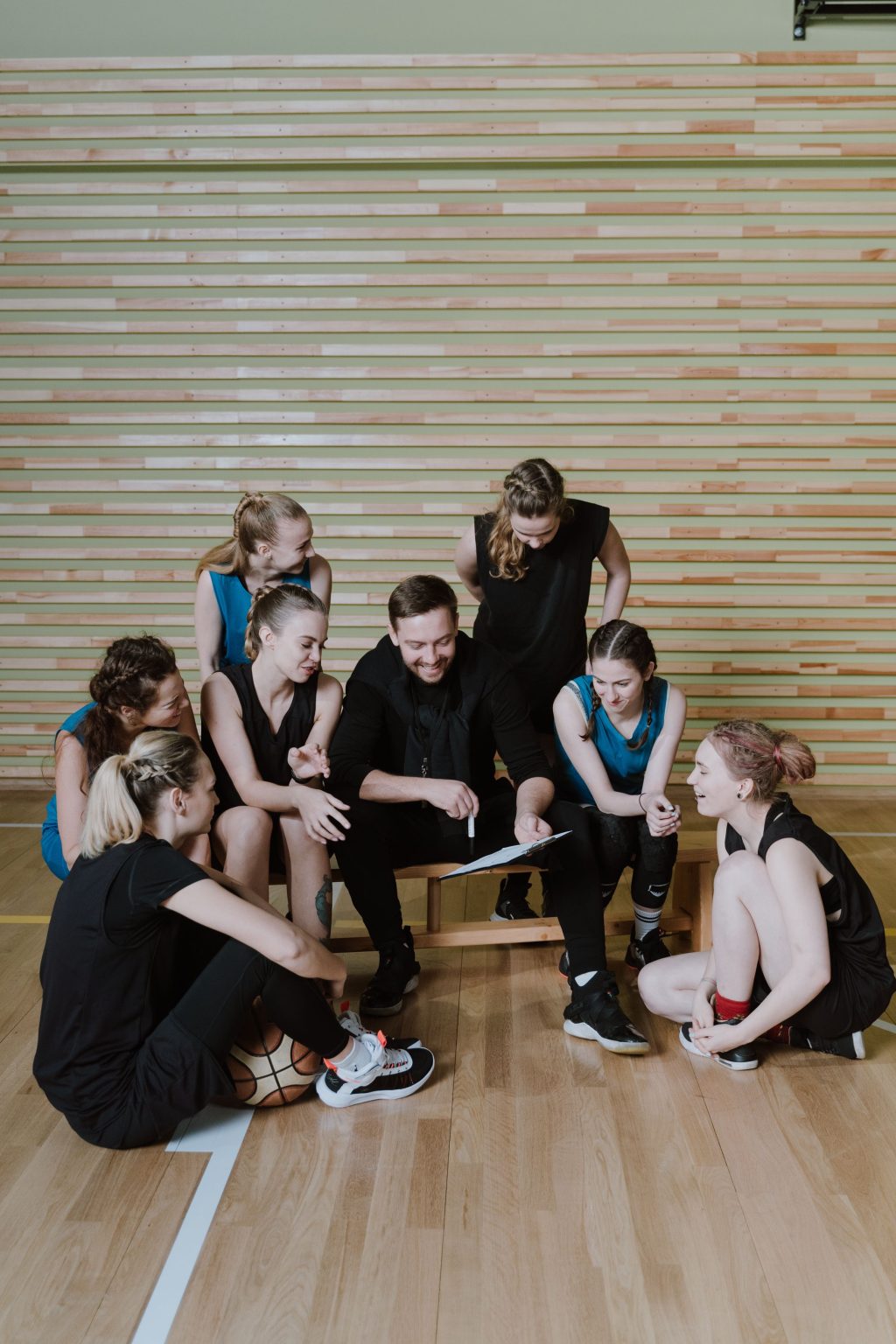 Basketball team and coach in a training huddle