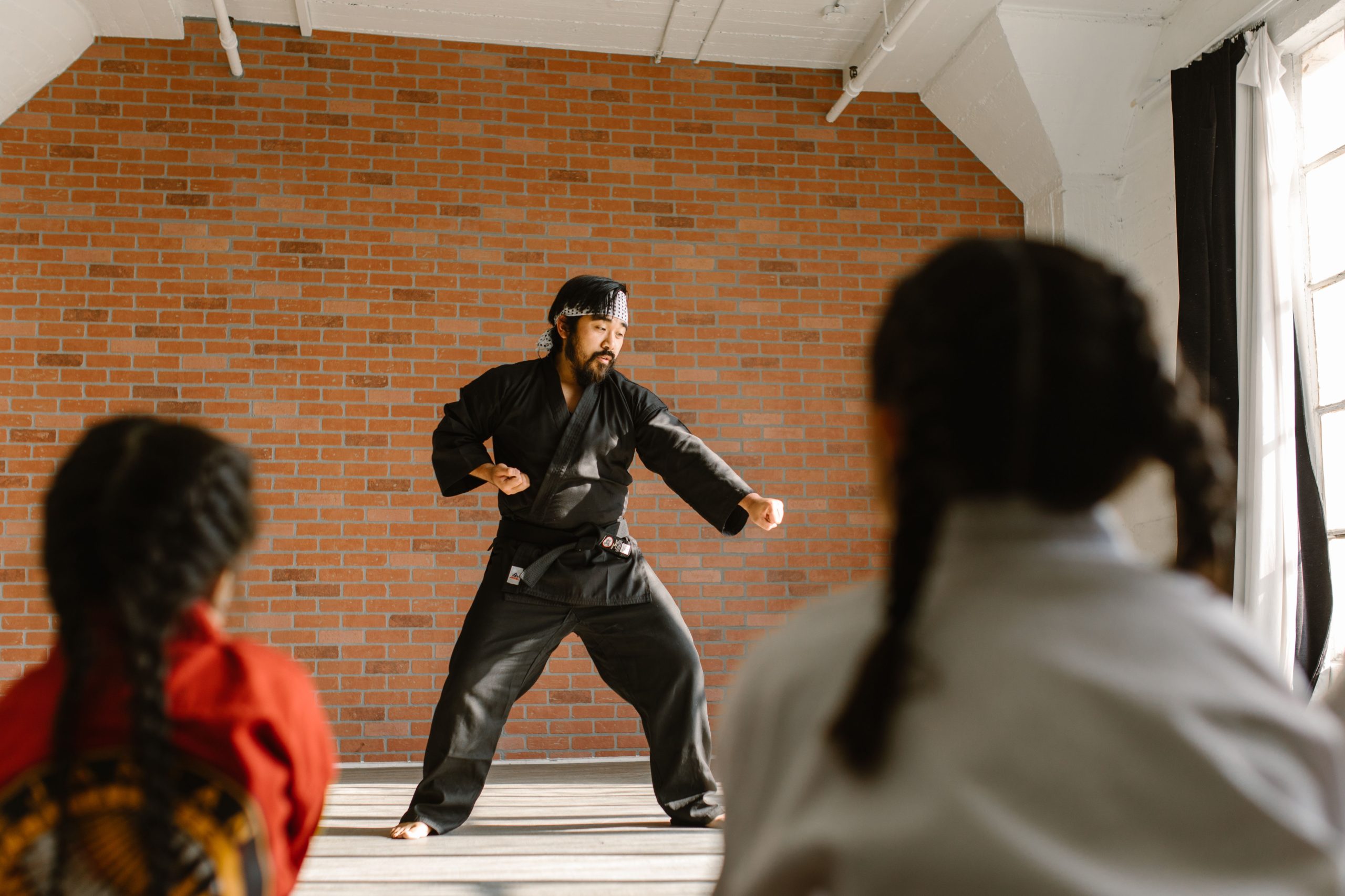 Martial arts instructor demonstrating technique to students