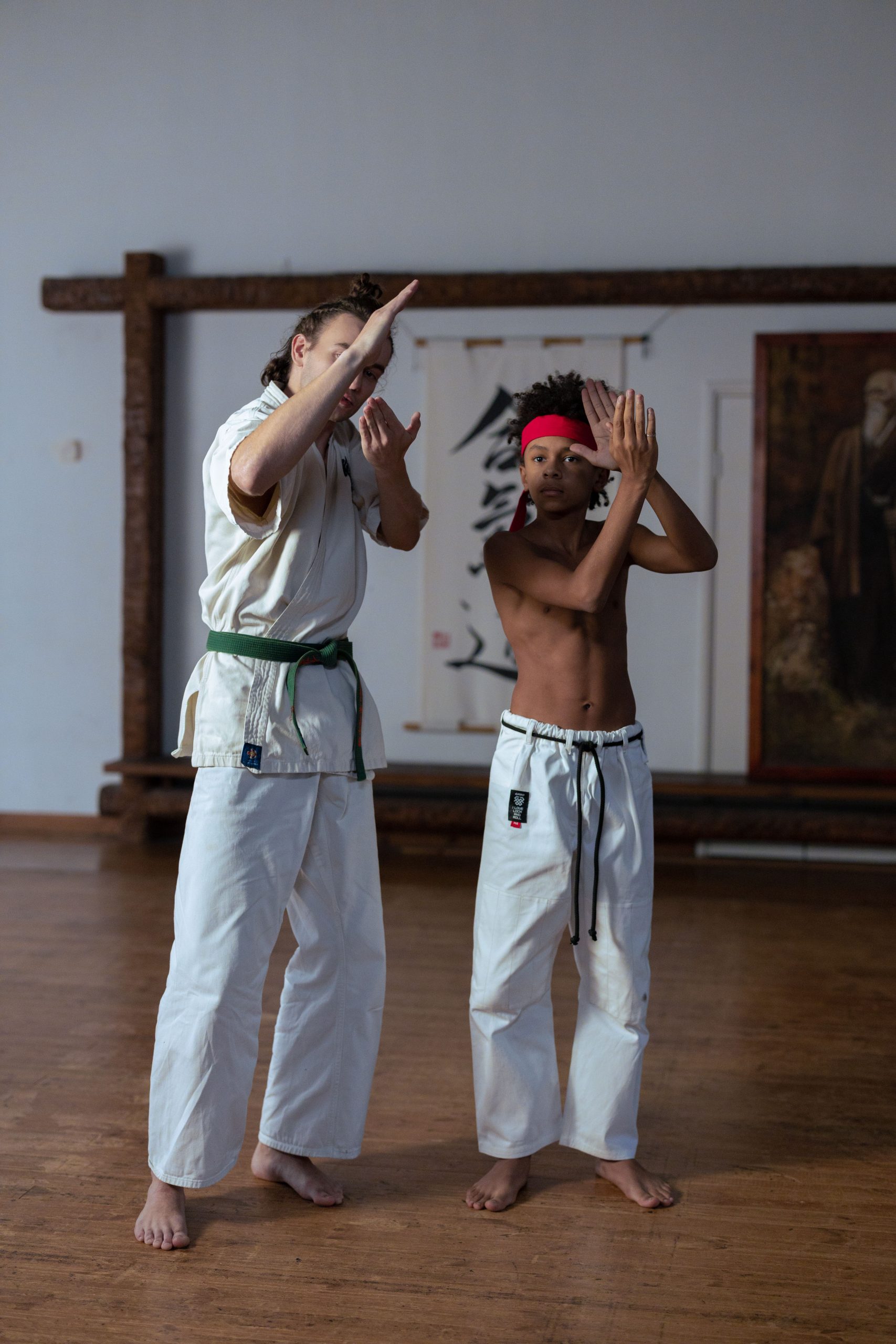 Martial arts instructor guiding a student through kata practice