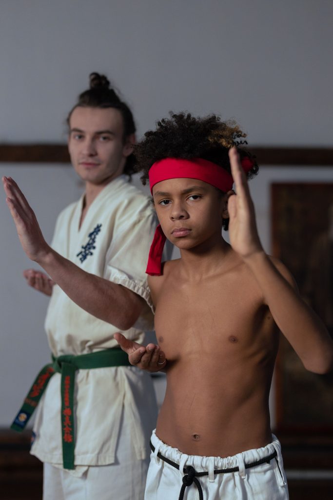 Young martial arts student training with an instructor