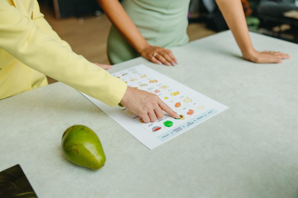 Nutrition coach explaining a food chart during a consultation