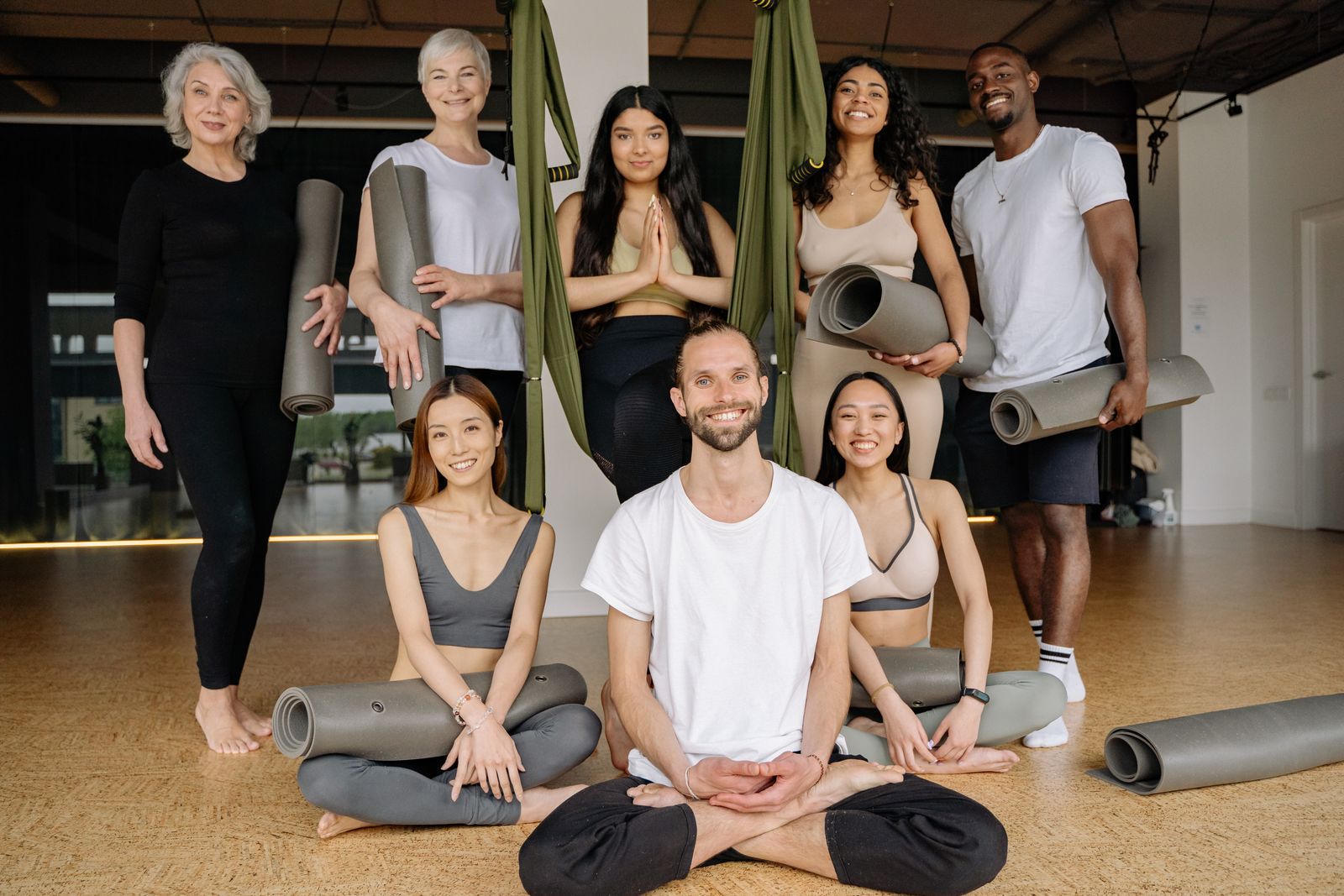Yoga teacher with a group in a bright studio