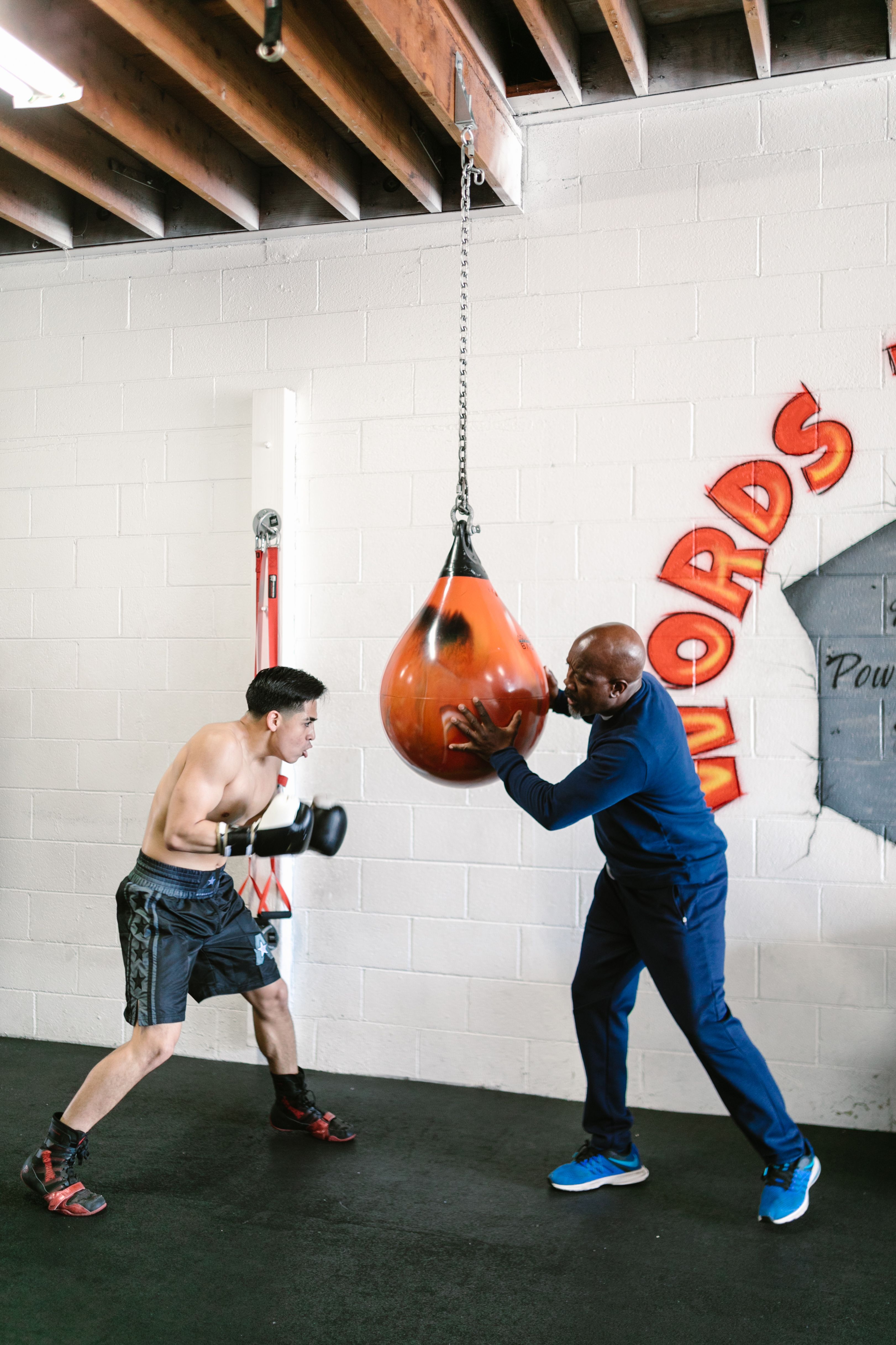 Male boxer wearing gloves in a boxing gym
