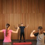 Fitness instructor leading an energetic group exercise class