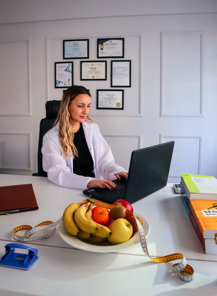 Nutritionist holding broccoli in a professional consultation office