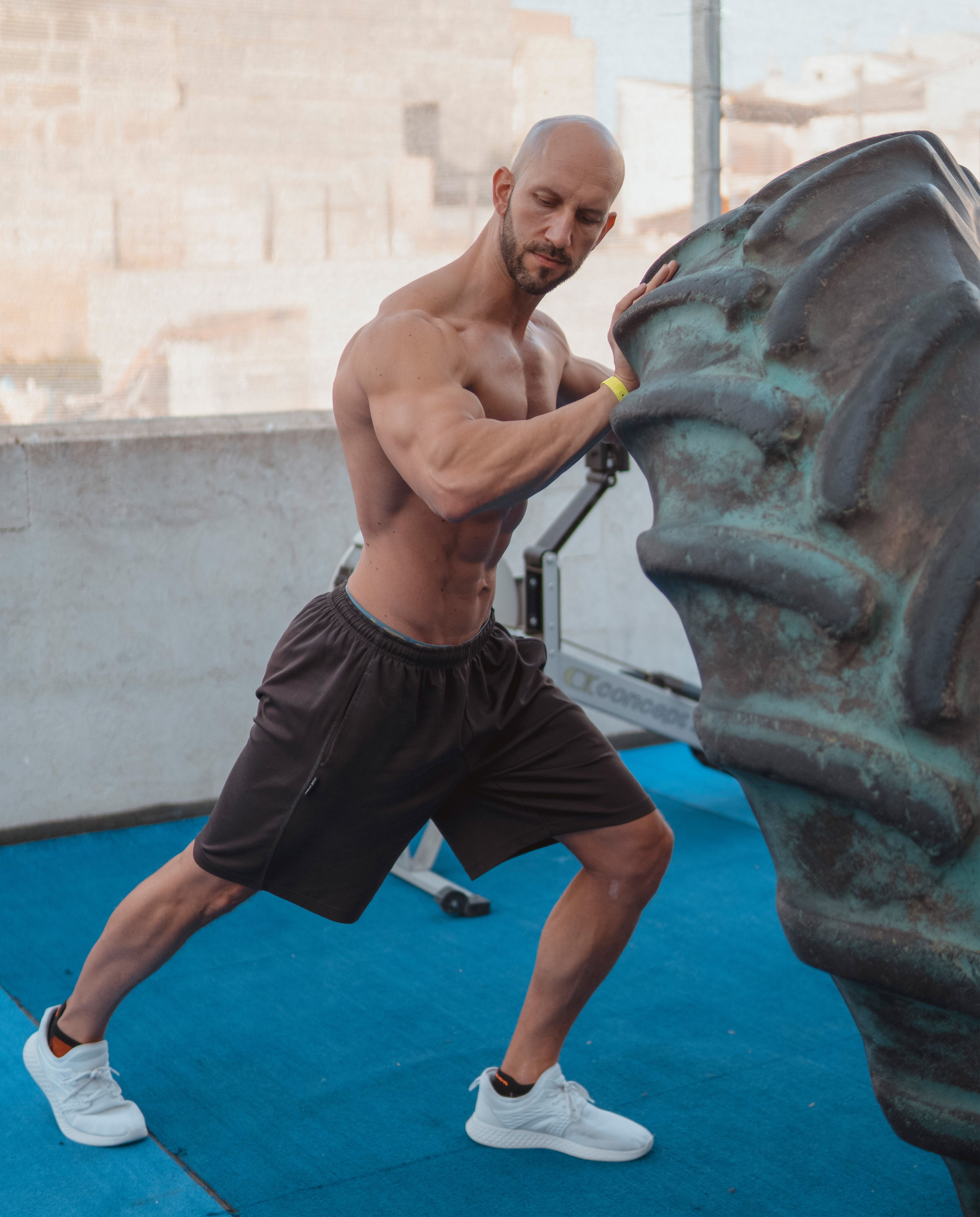Personal trainer coaching an athlete through a gym workout