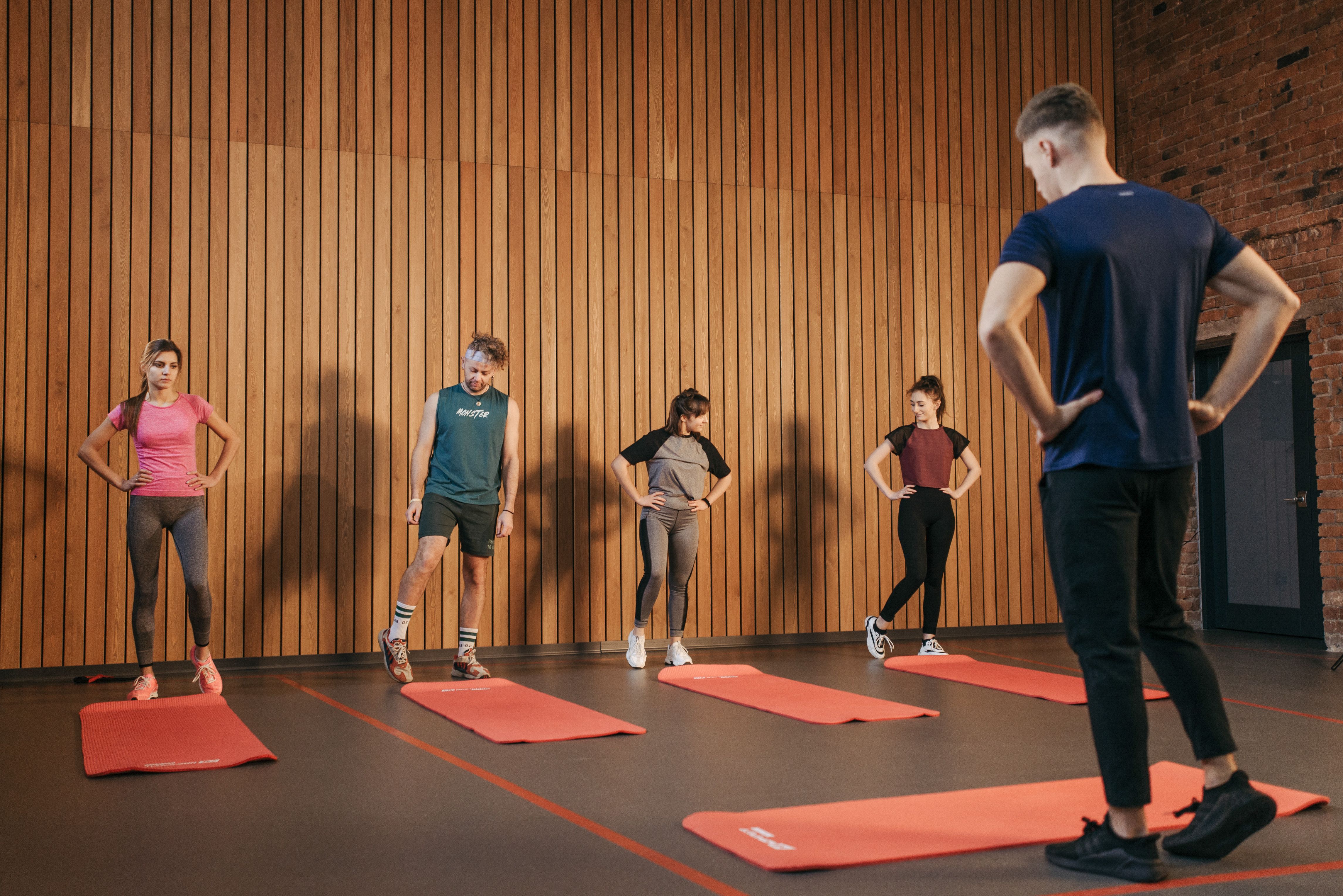 Personal trainer coaching an athlete through a gym workout