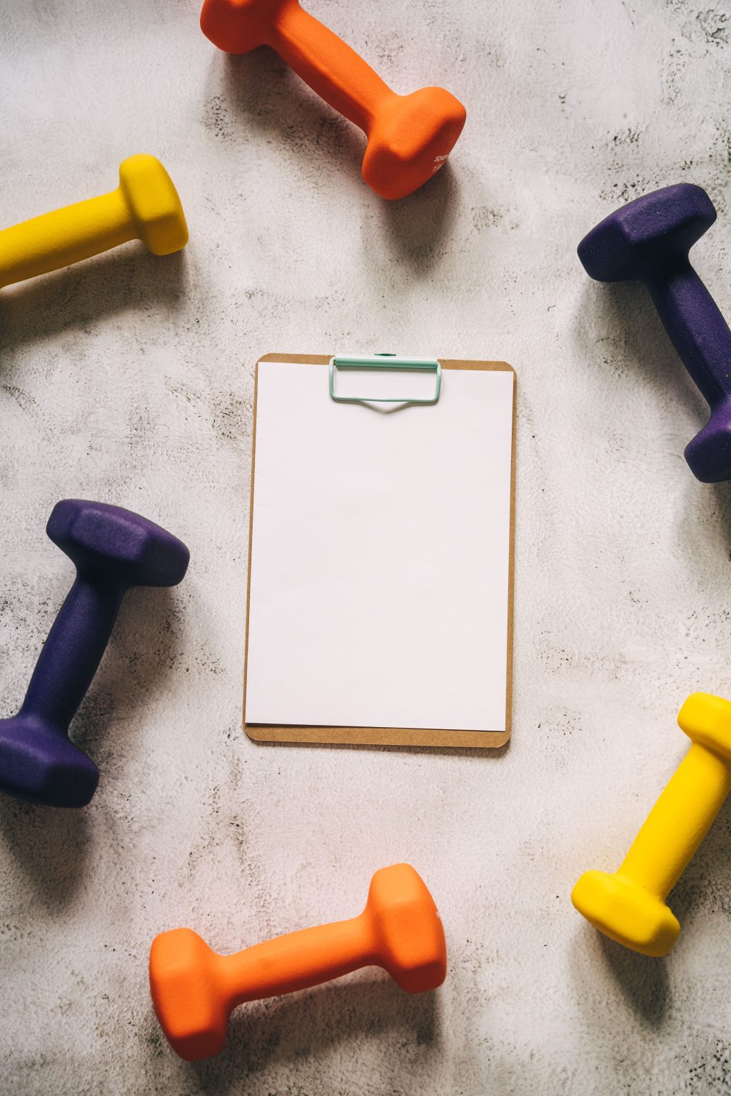 Personal trainer reviewing fitness notes and training ideas