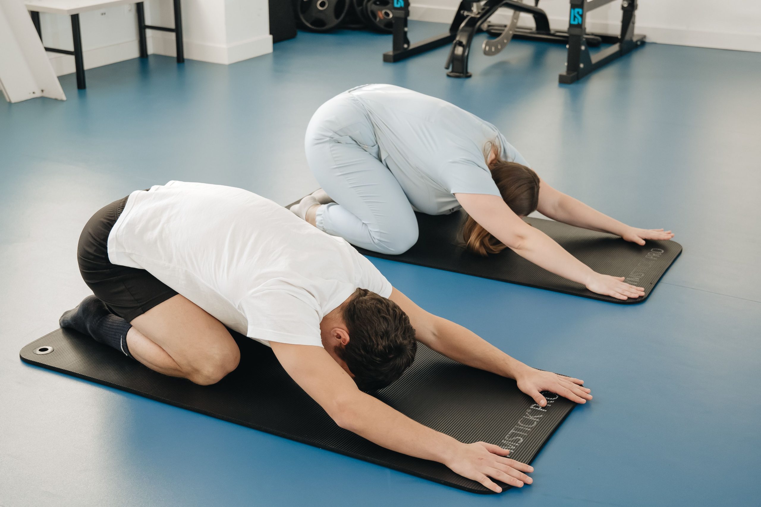 Sports Physiotherapist Stretching Athlete