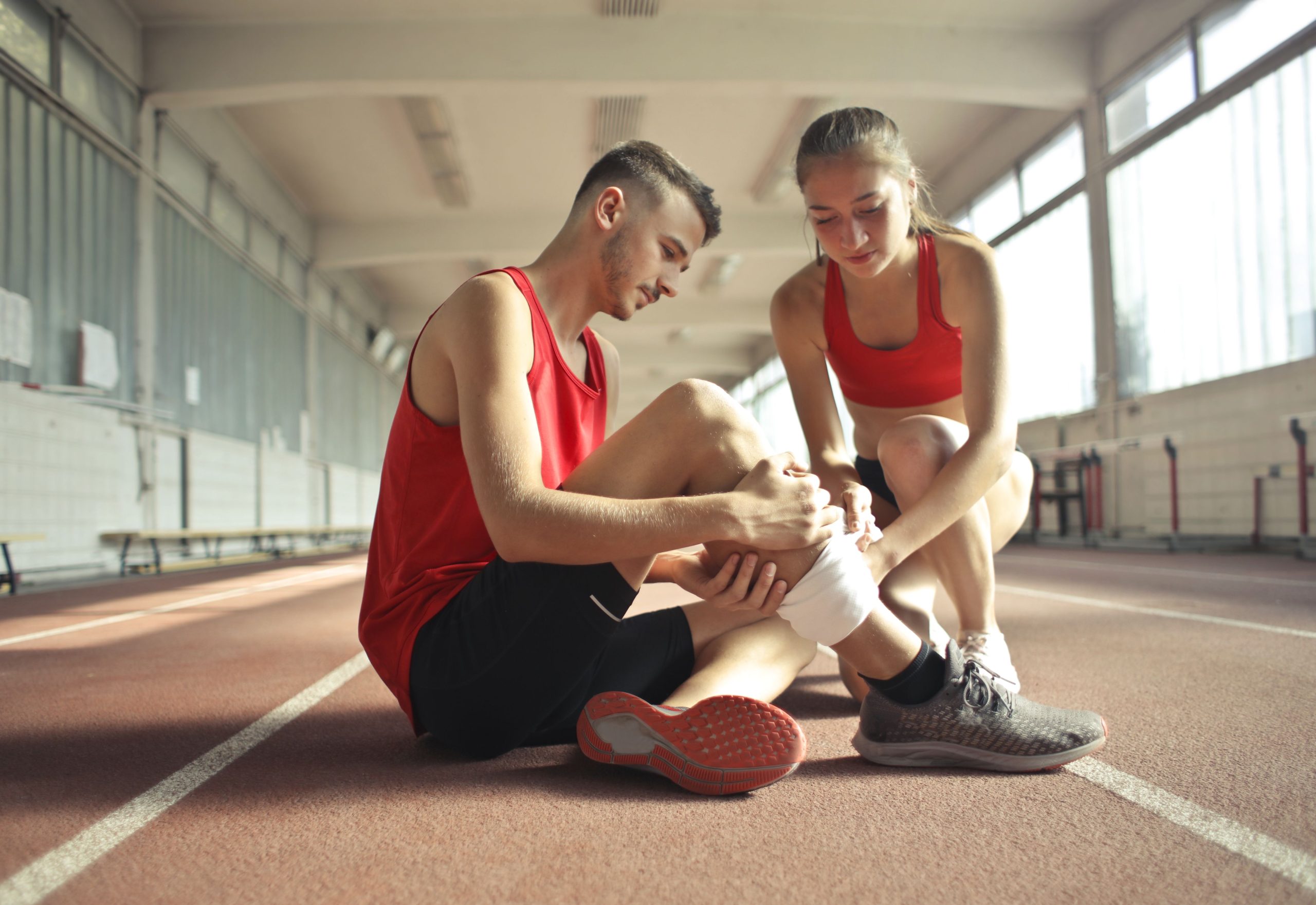 Therapist applying kinesiology tape for sports rehabilitation
