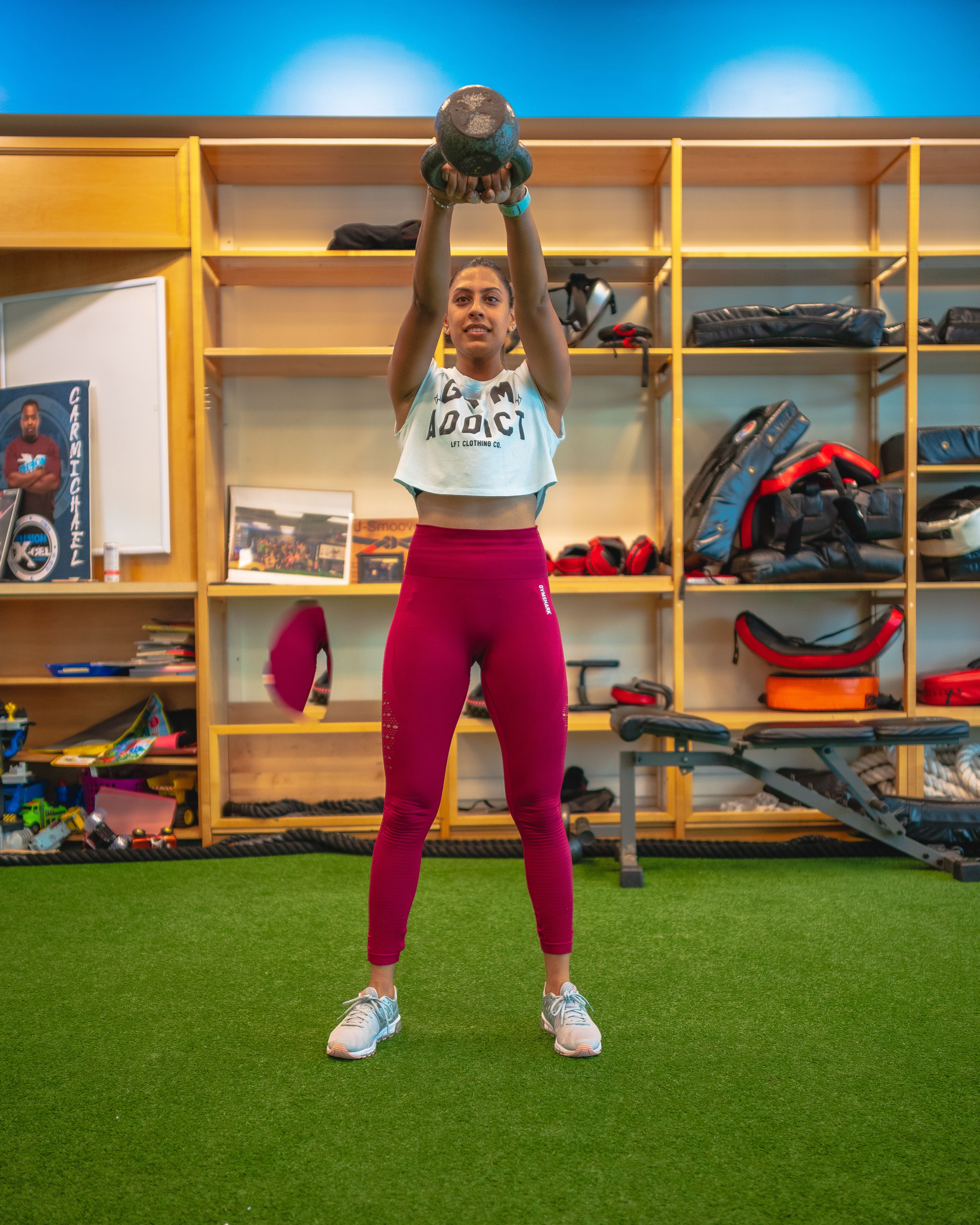 Women performing a coached squat workout