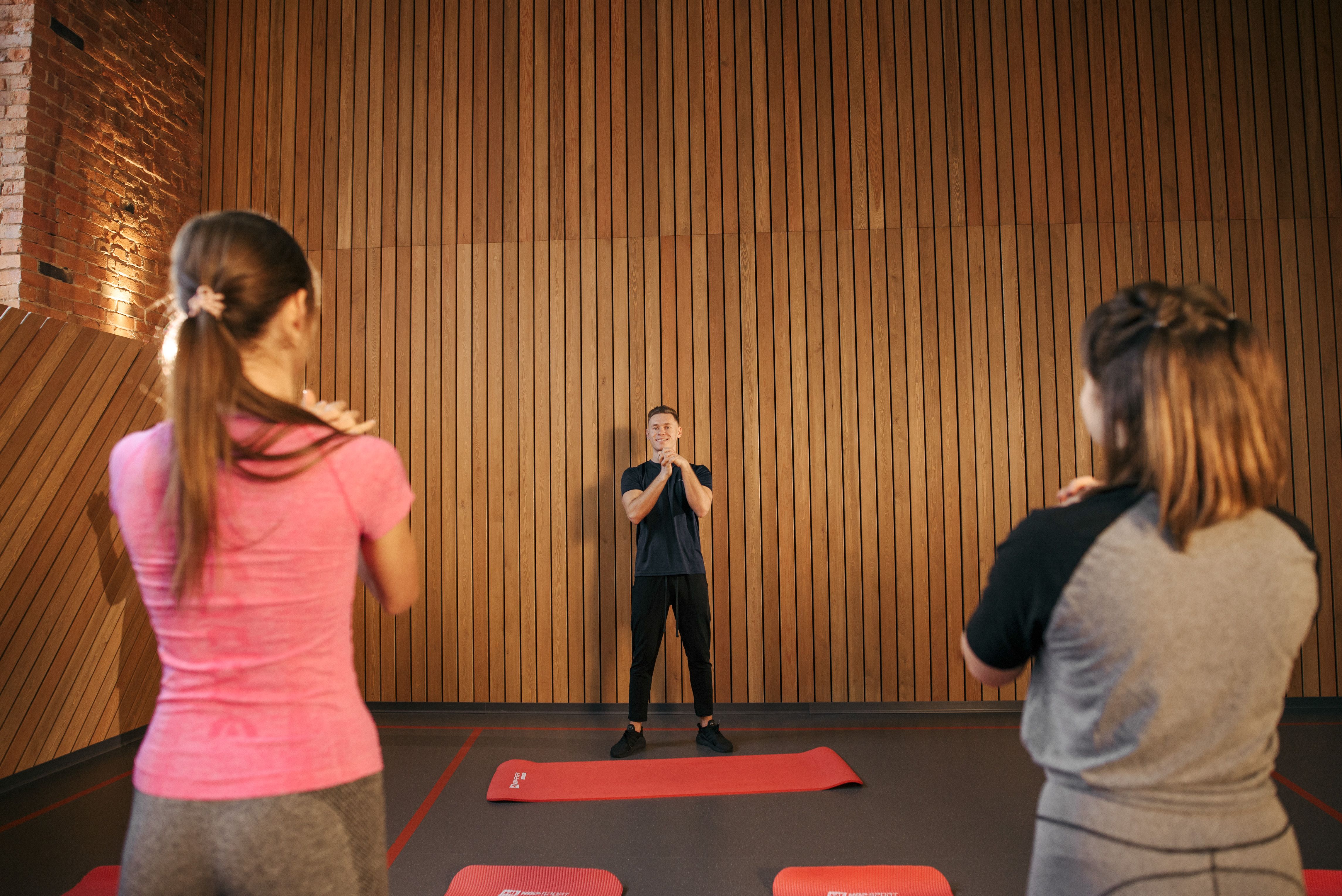 Woman practicing boxing with a trainer in a boxing gym
