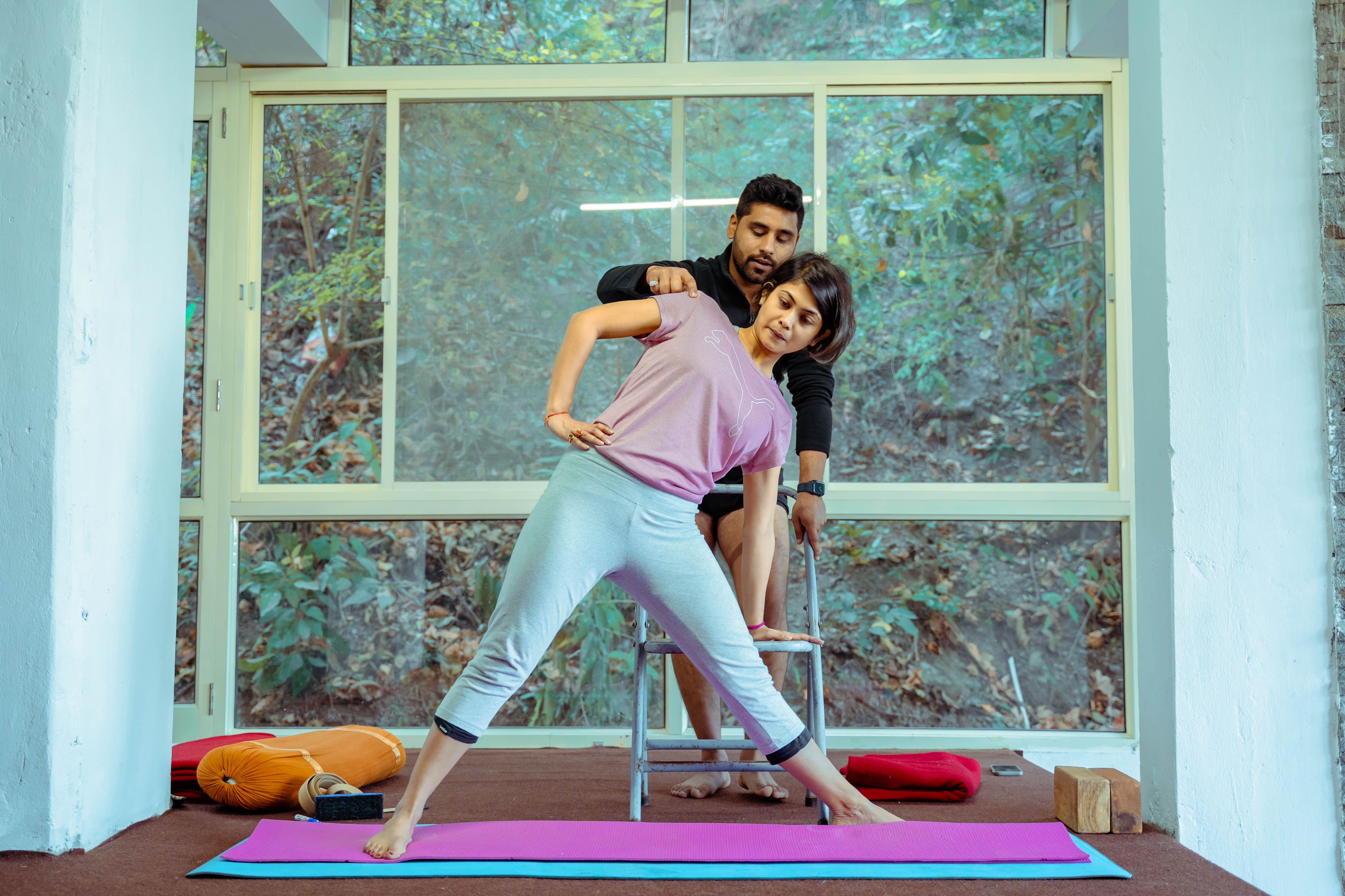 Yoga teacher with a group in a bright studio