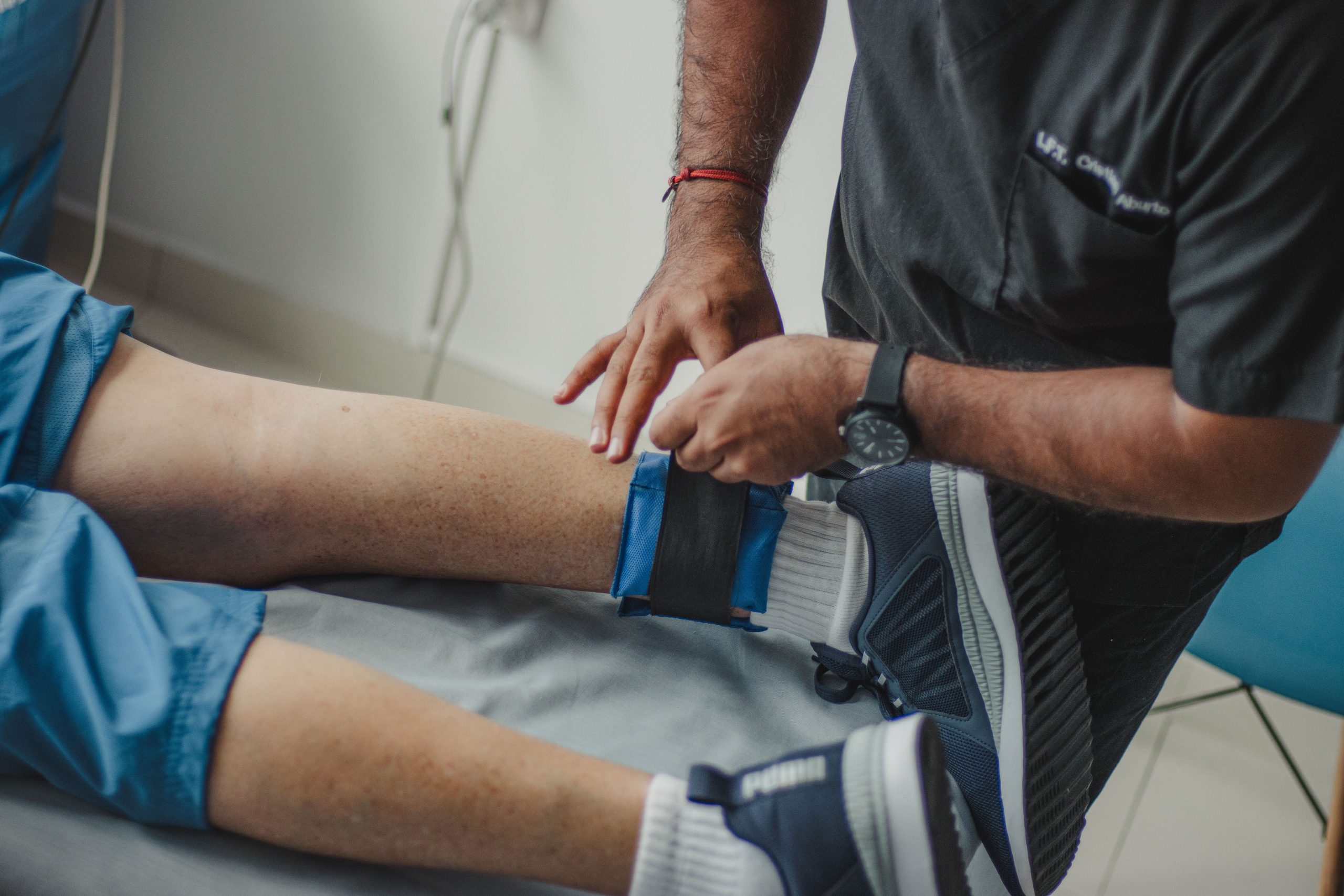 Sports therapist treating an athlete on a football field