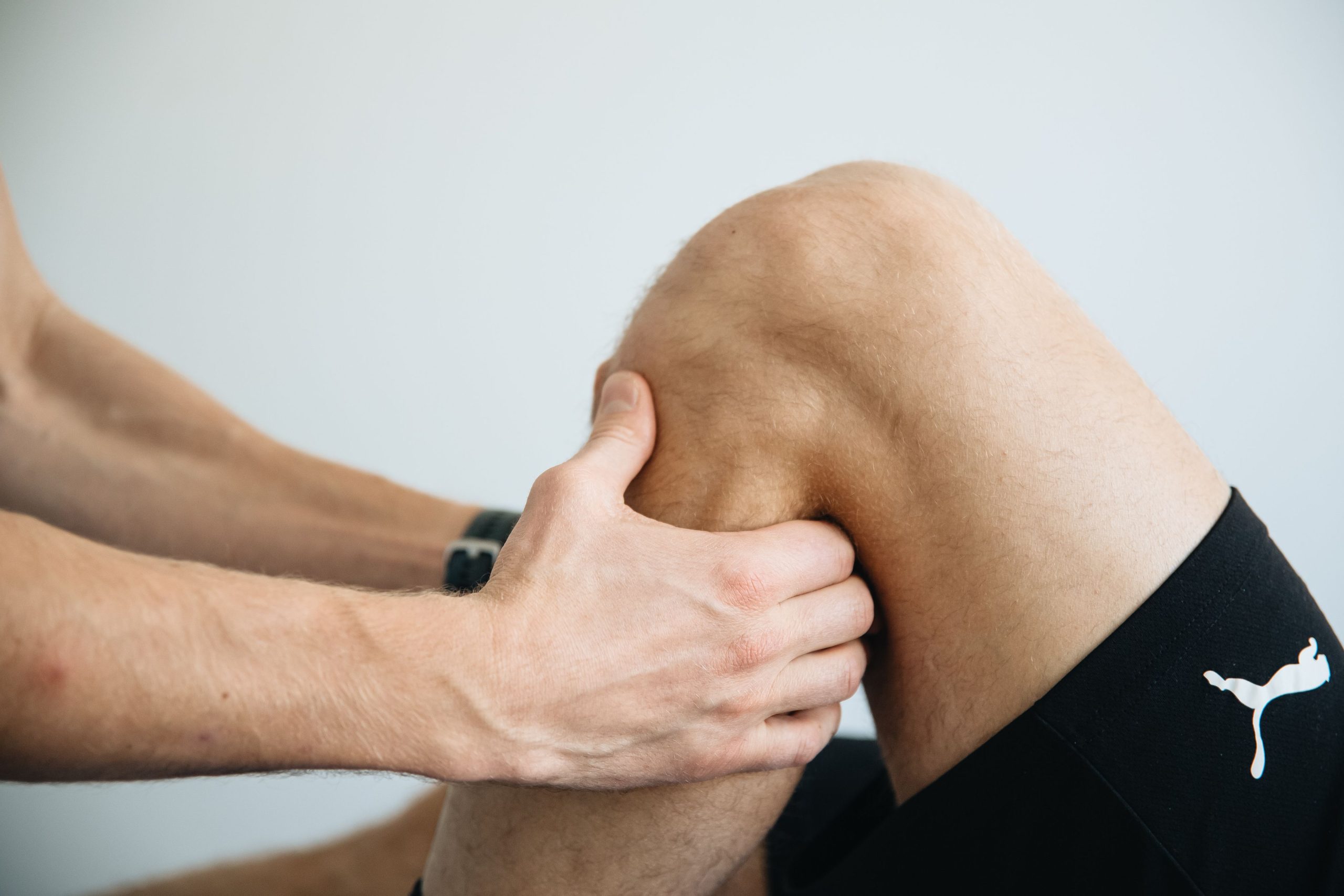 Athlete receiving assisted recovery treatment during rehabilitation