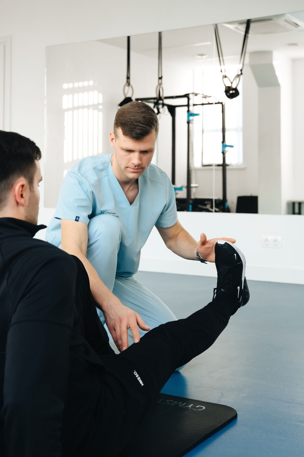 Sports therapist treating an athlete on a football field