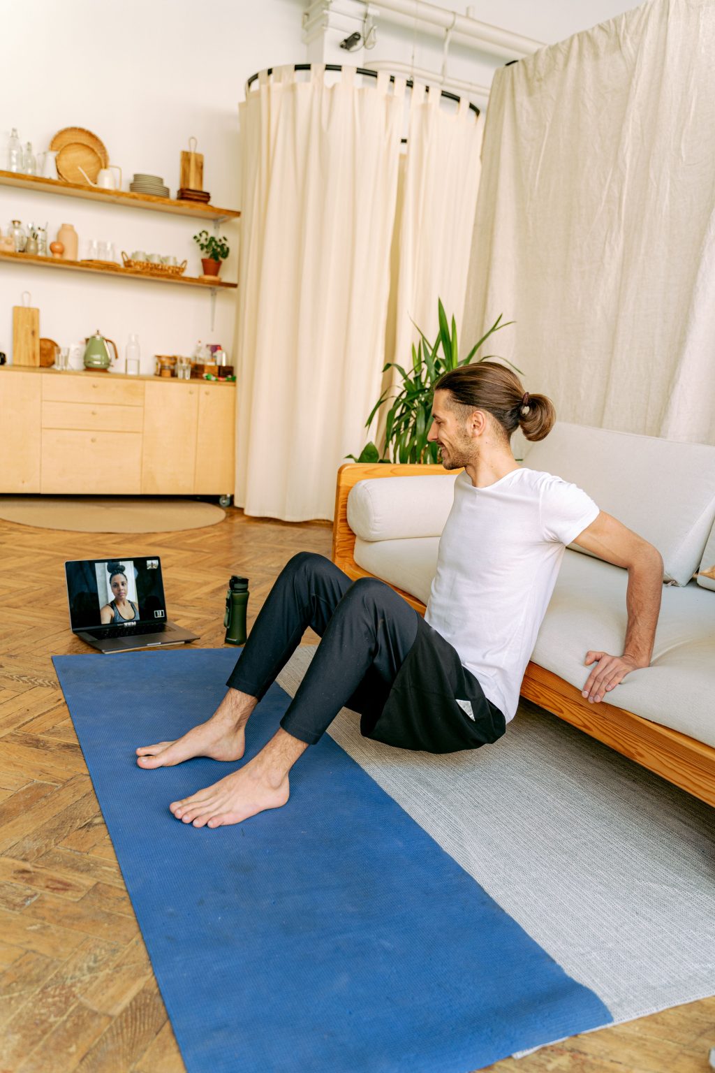 Online personal trainer coaching a client by video