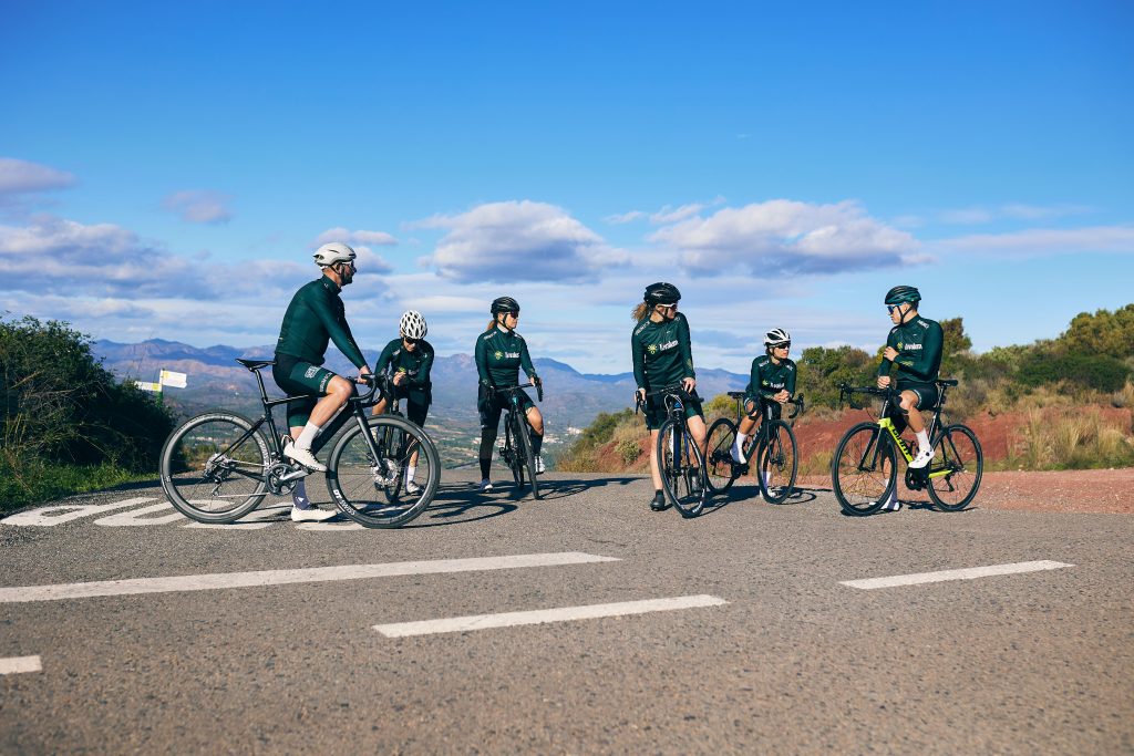 Cyclists pausing together beside their road bikes