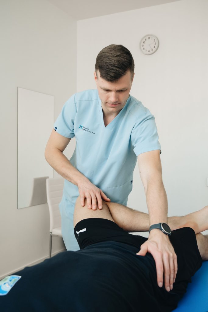 Physiotherapist providing hands-on hip and leg treatment