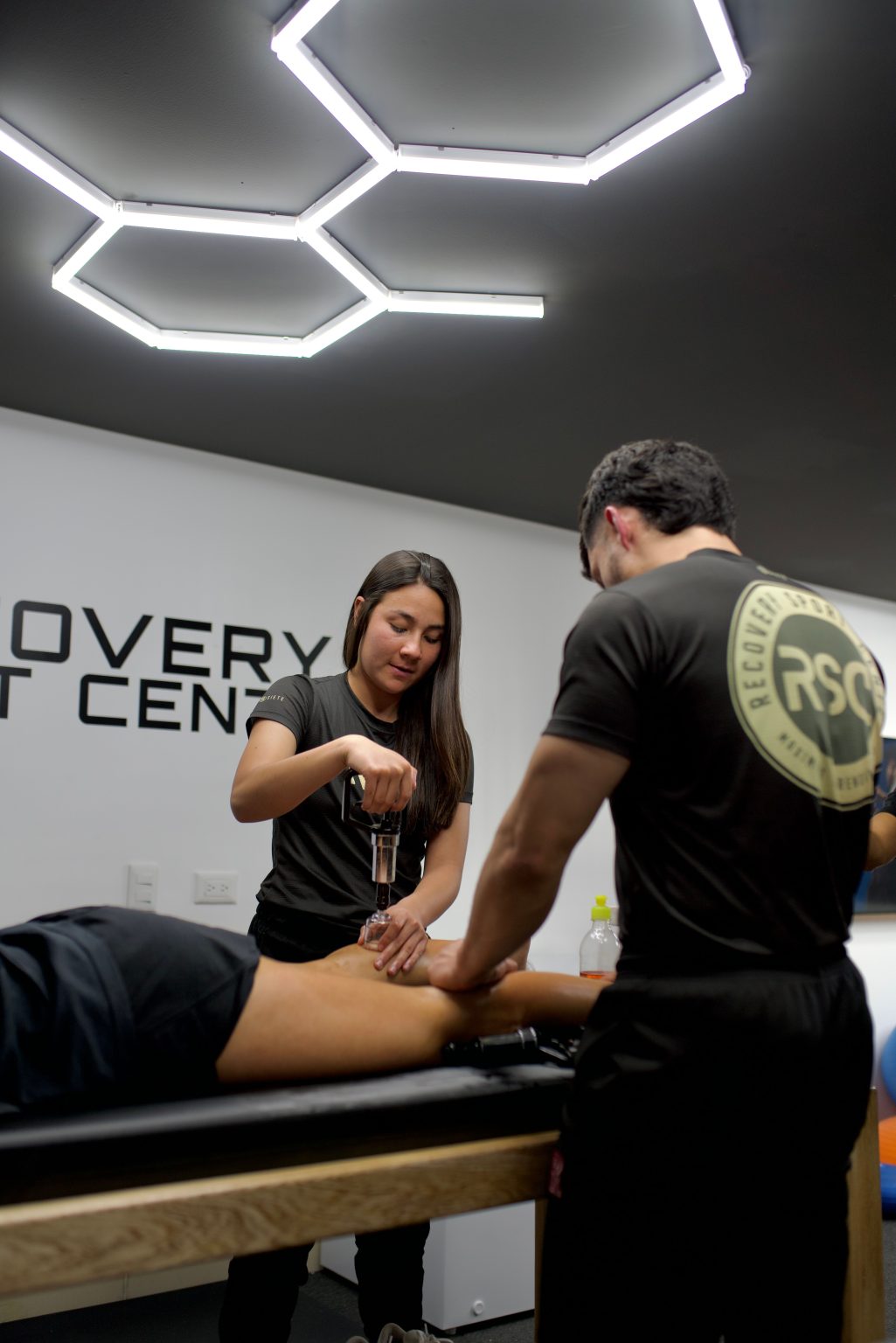 Physiotherapists providing treatment in a sports recovery clinic