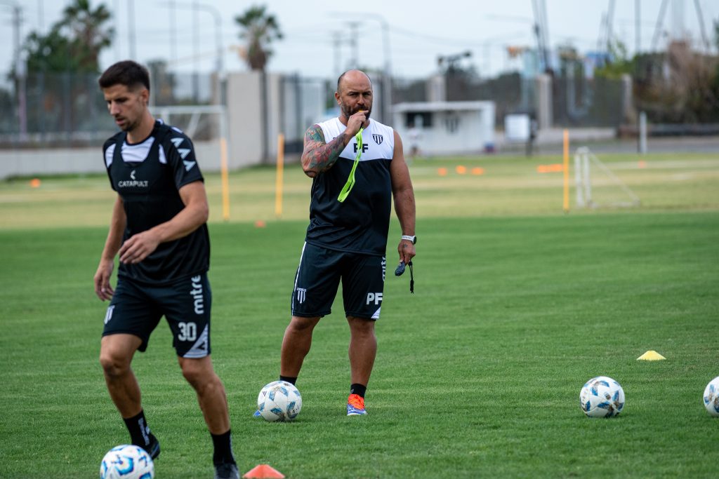 Sports coach instructing players during outdoor training