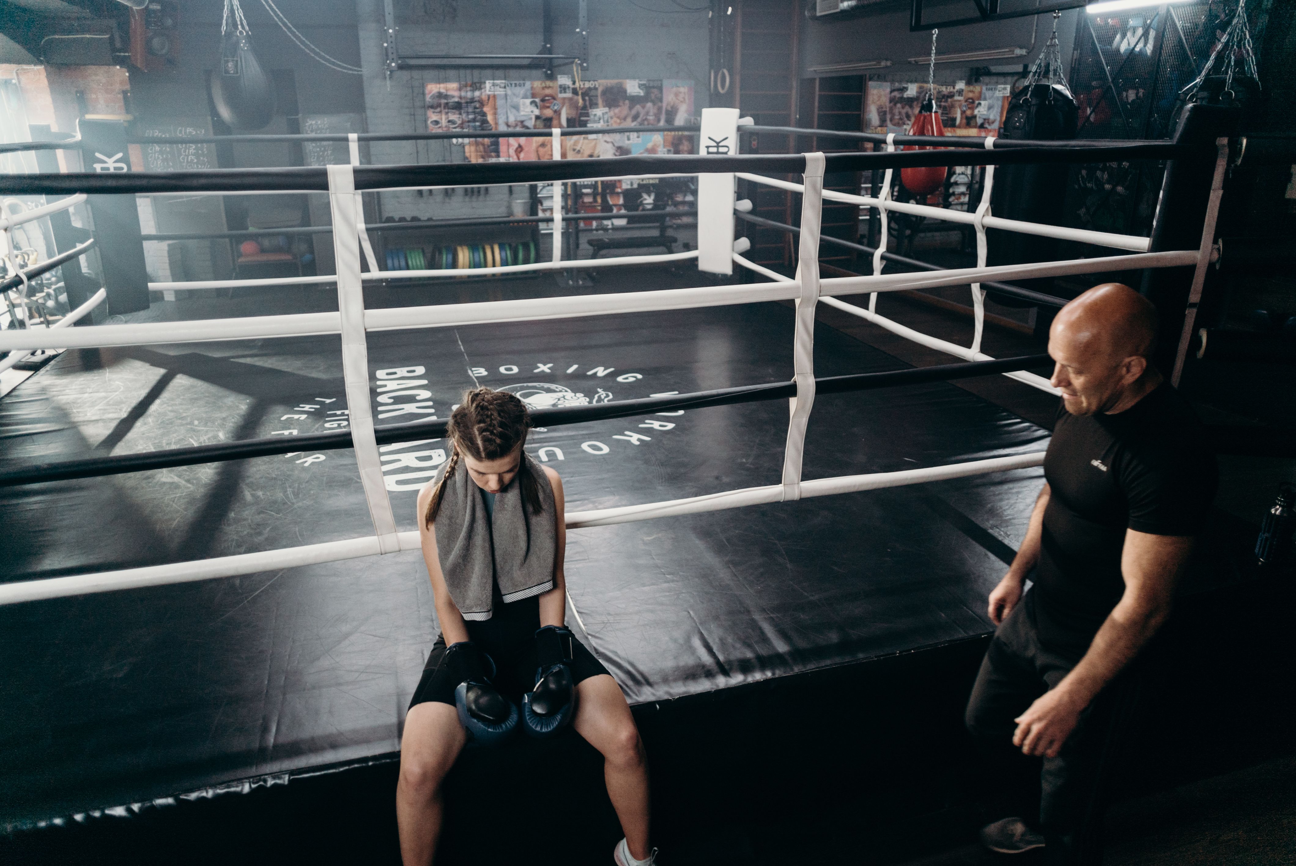 Boxing coach training with focus mitts