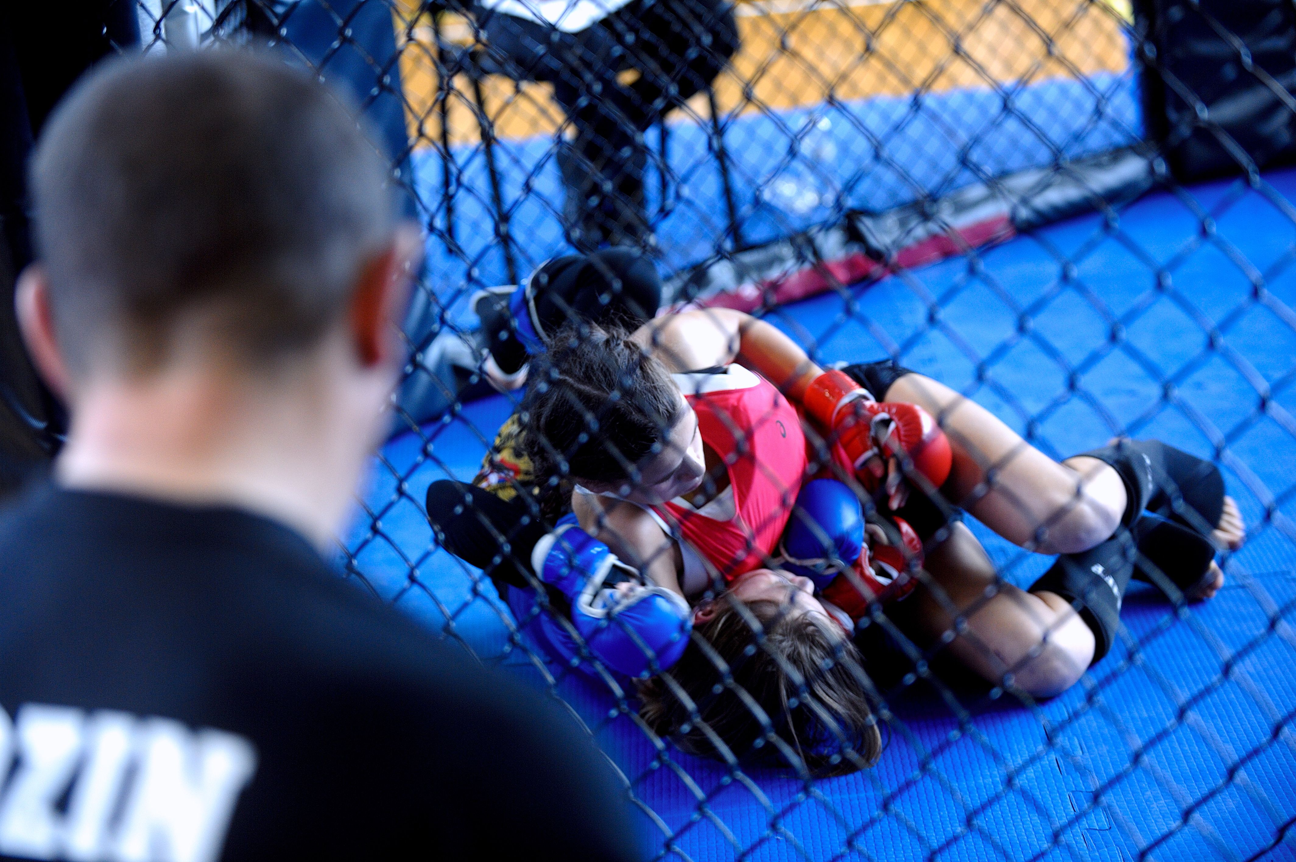 Female boxer training with a coach in a boxing ring