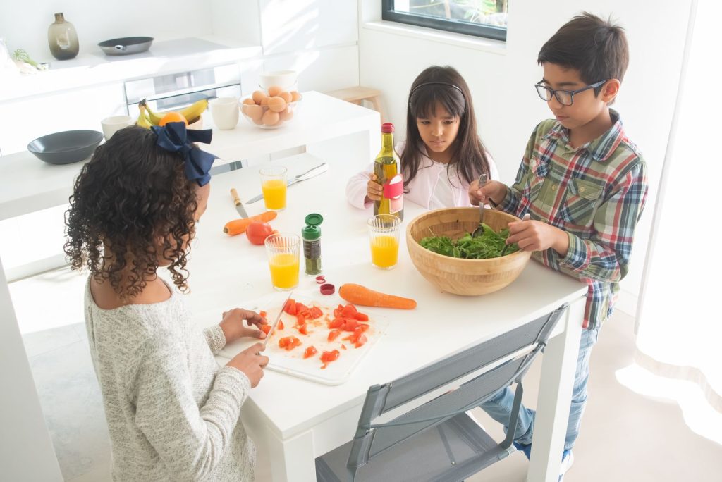 Woman holding avocado while preparing healthy food