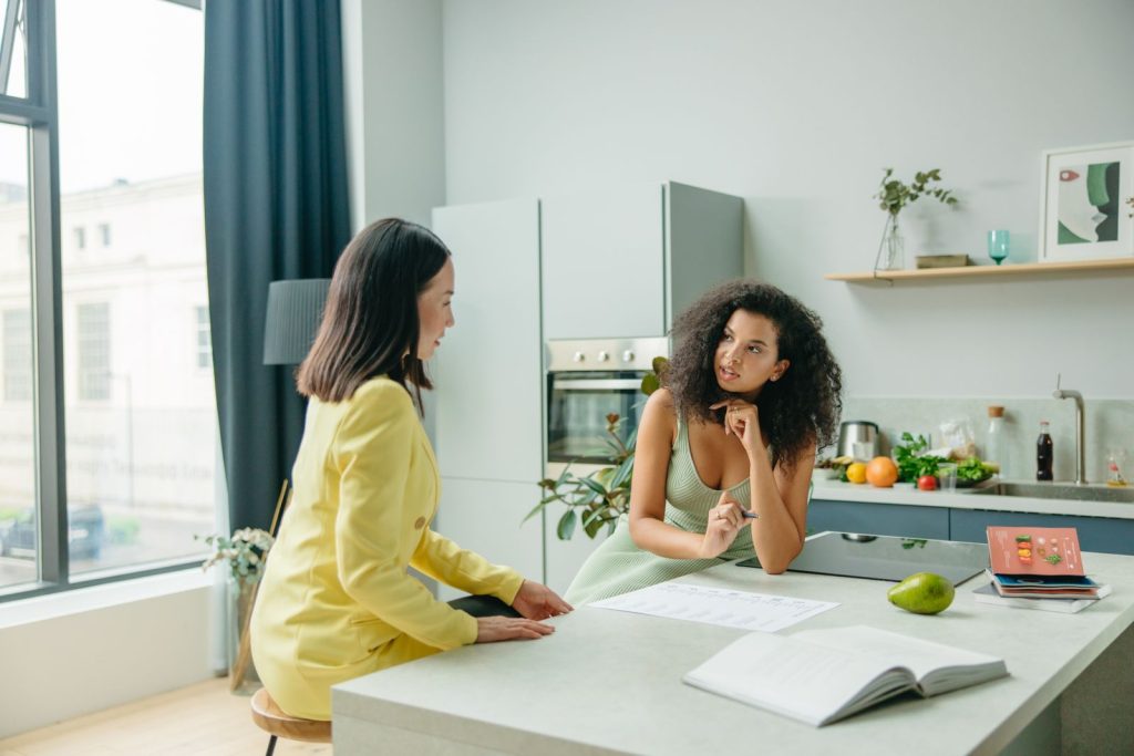 Nutrition coach explaining a food chart during a consultation