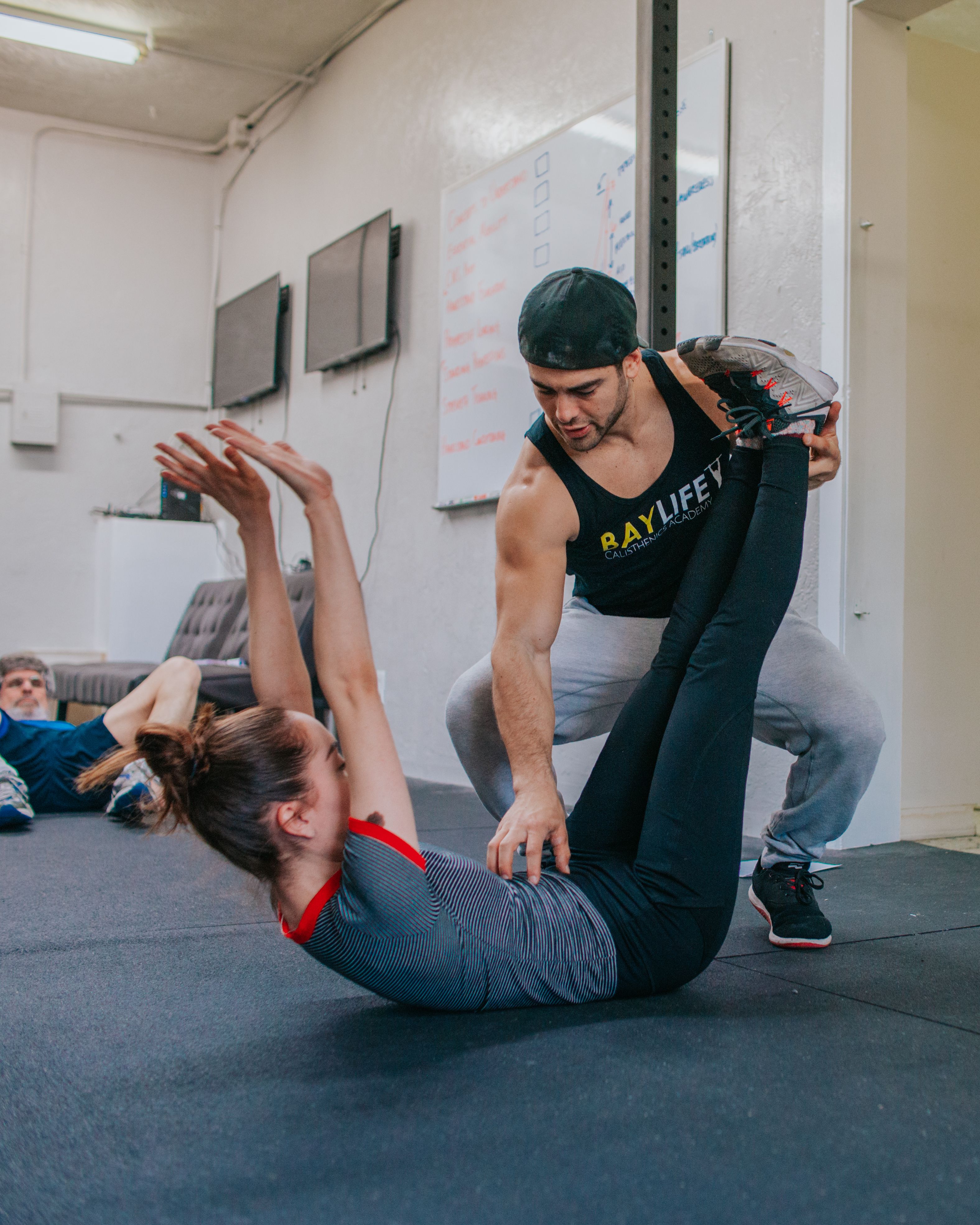 Personal trainer coaching an athlete through a gym workout