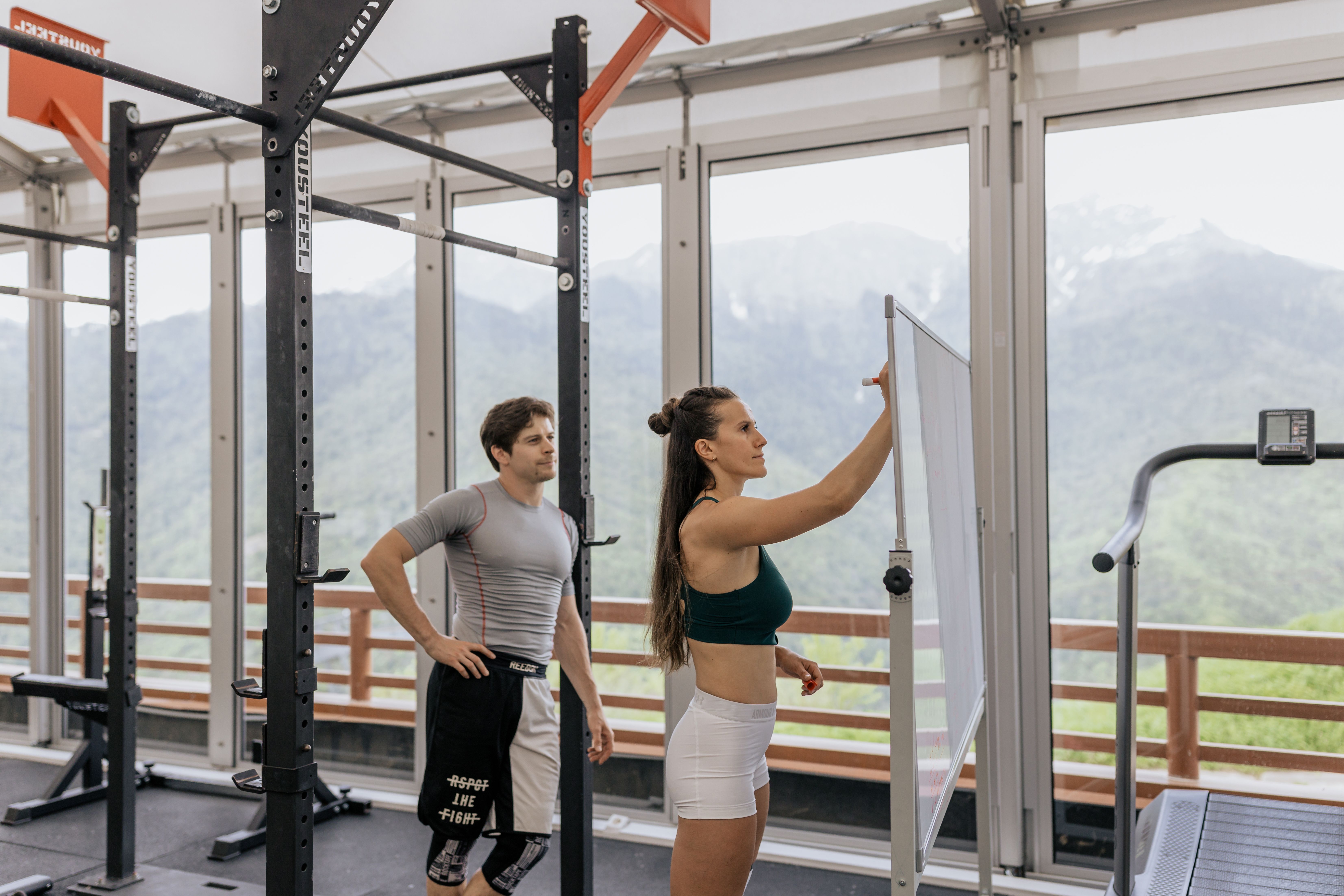 Personal trainer reviewing fitness notes and training ideas