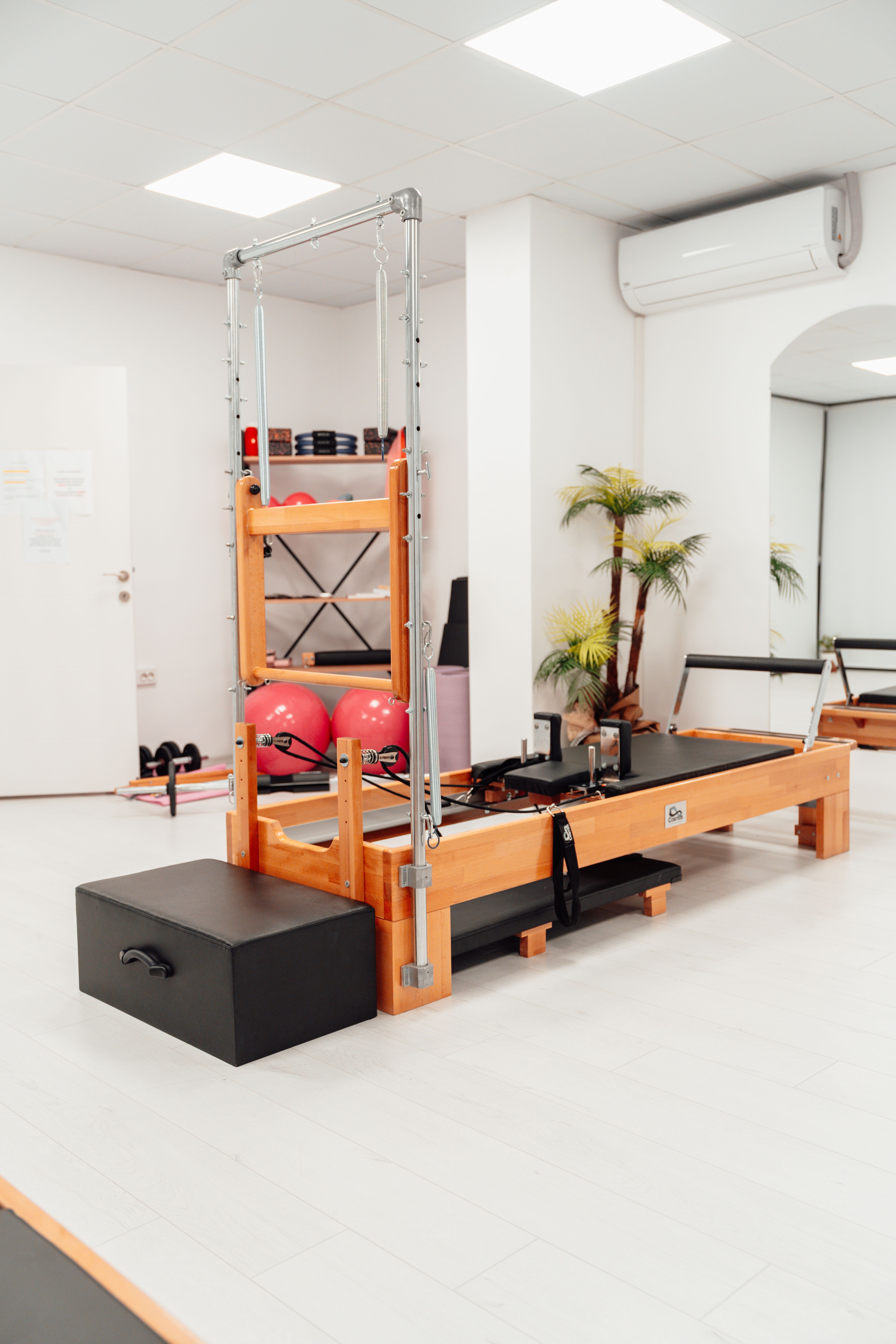 Pilates instructor leading a reformer studio class